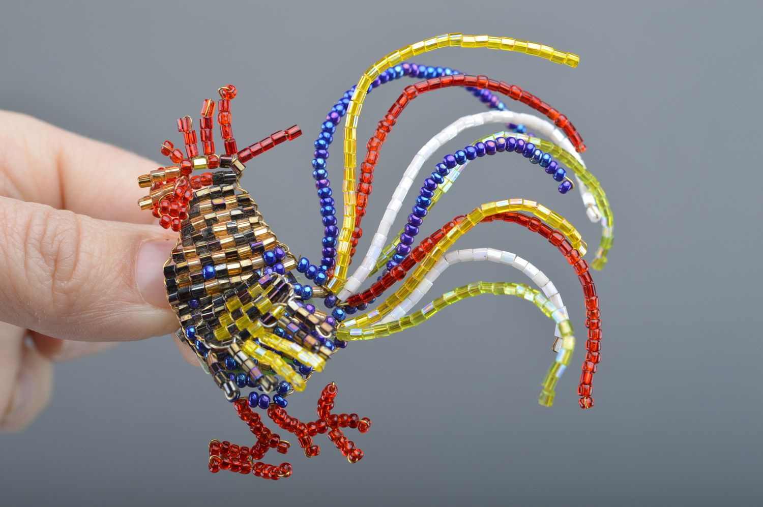 Unusual multi-colored beaded brooch hand woven with fishing line in the shape of cock photo 1