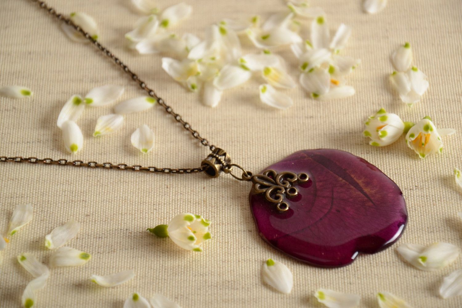Violet handmade neck pendant with flower petal coated with epoxy photo 1