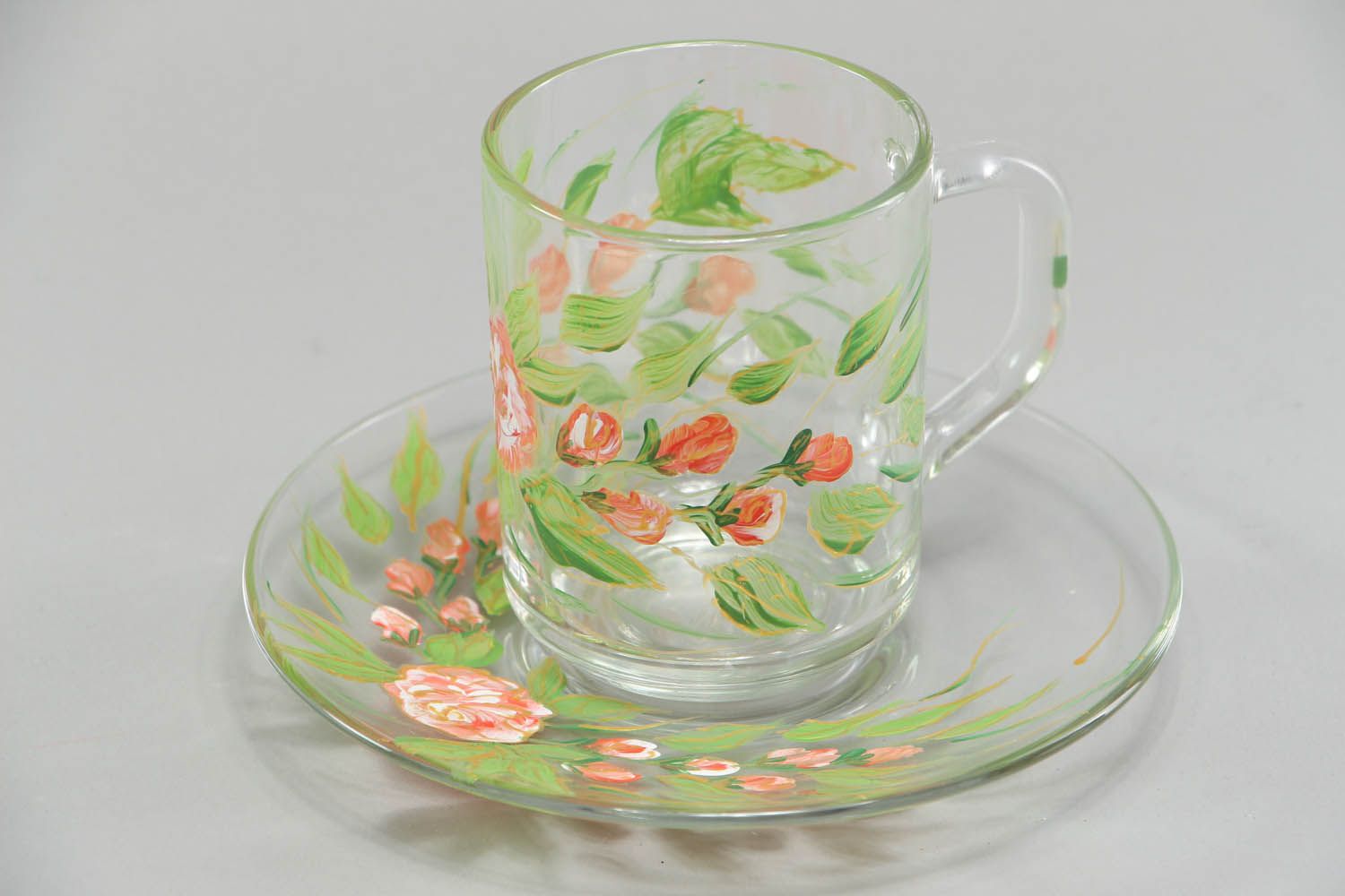 Clear glass tea cup with handle and saucer in green floral pattern photo 1