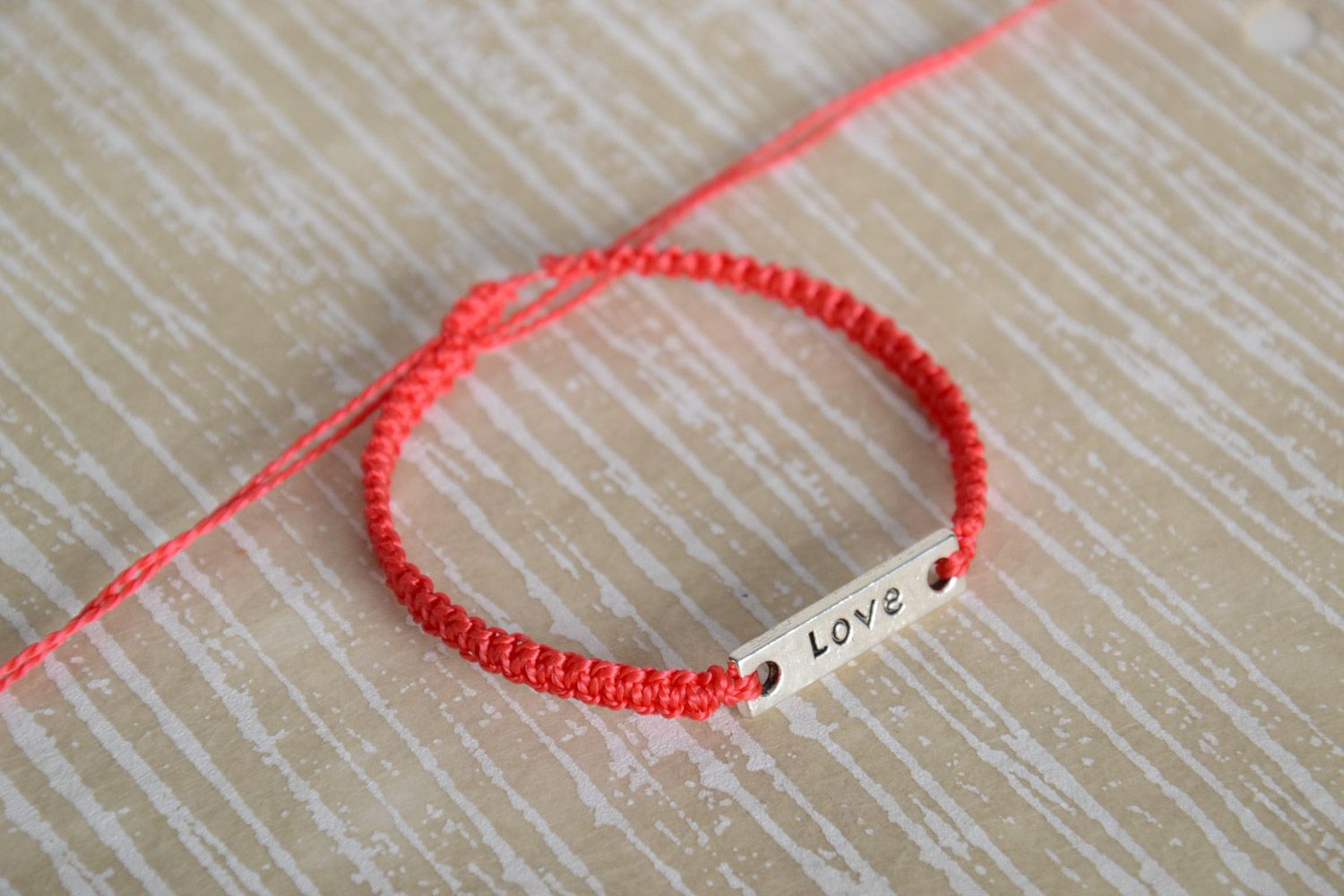 Handmade women's macrame woven bracelet of red color with metal lettering Love photo 1