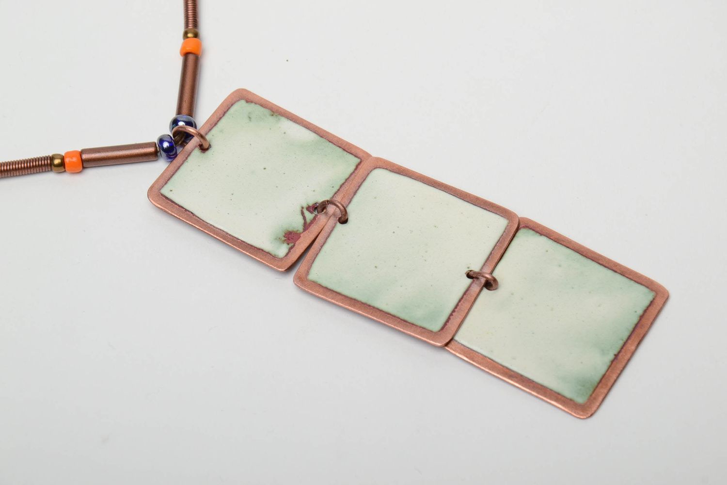 Long copper pendant with three square elements photo 5