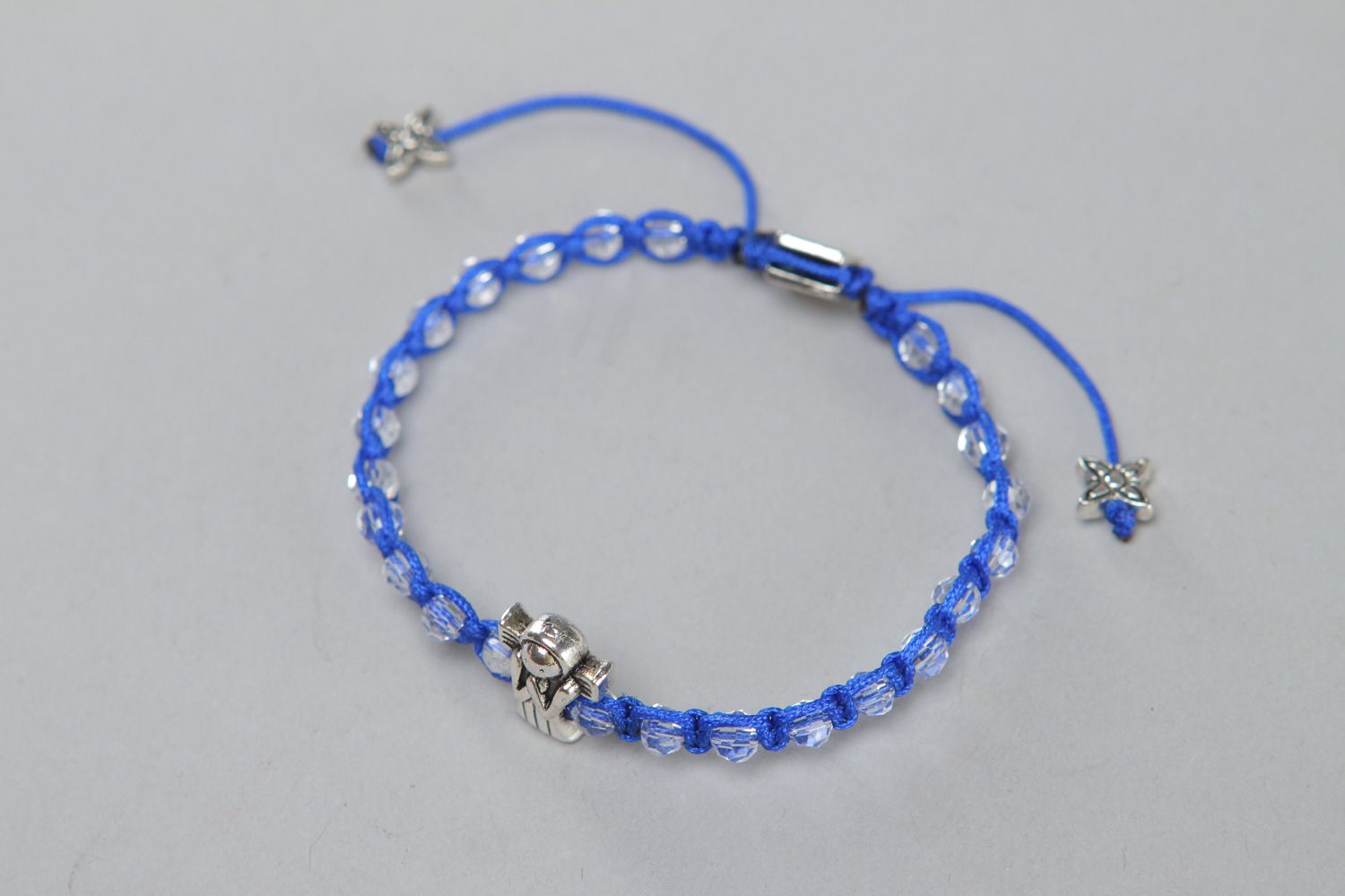 Handmade friendship wrist bracelet woven of blue cord with beads and metal element photo 1