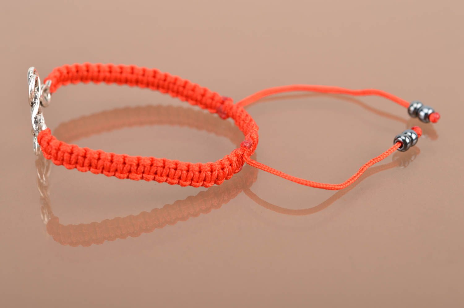 Handmade beautiful red bracelet made of silk threads with metal insert photo 5