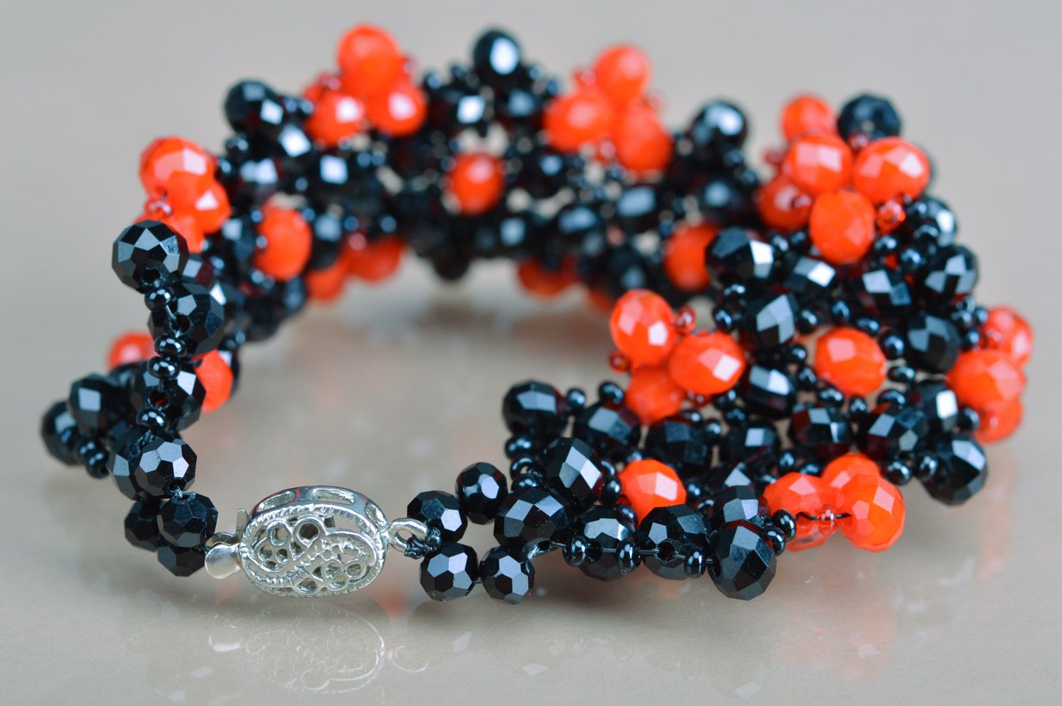 Handmade beautiful wrist bracelet woven of red and black agate and coral beads photo 5