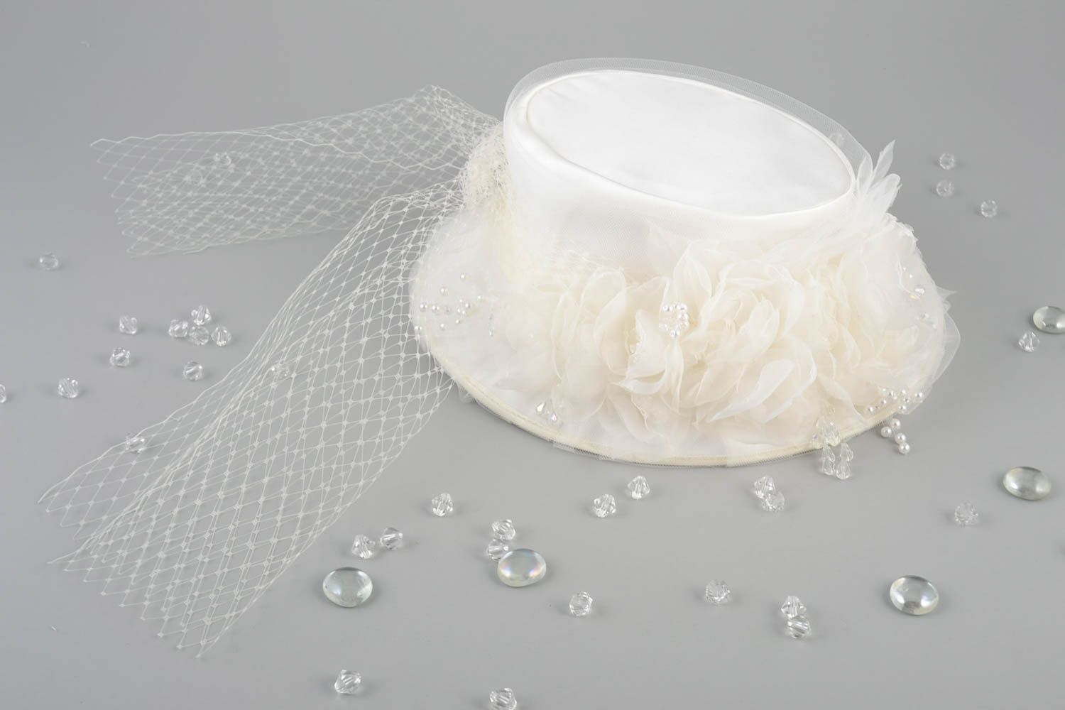 Unusual small handmade stylish designer bridal hat with veil of milky color photo 1