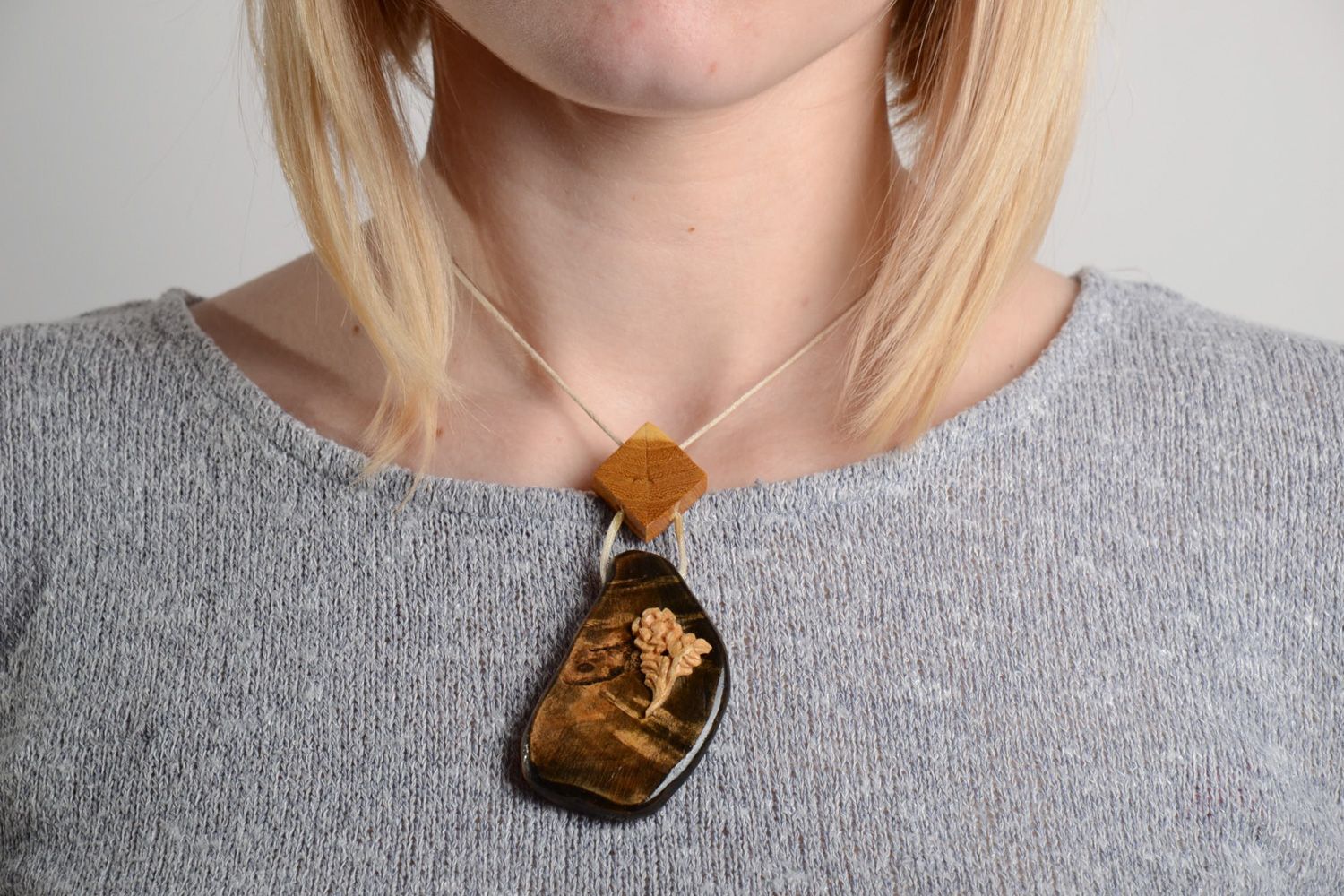 Beautiful handmade neck pendant carved of wood and varnished with synthetic cord photo 2