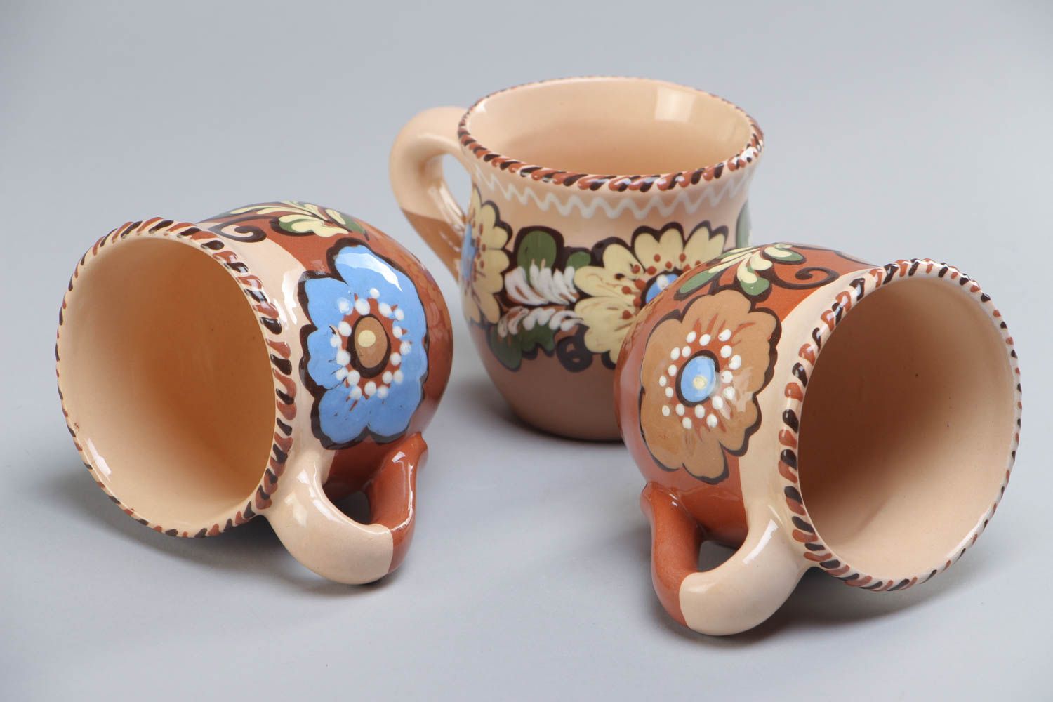 Set of three glazed village-style tea cups with painted flower pattern photo 4
