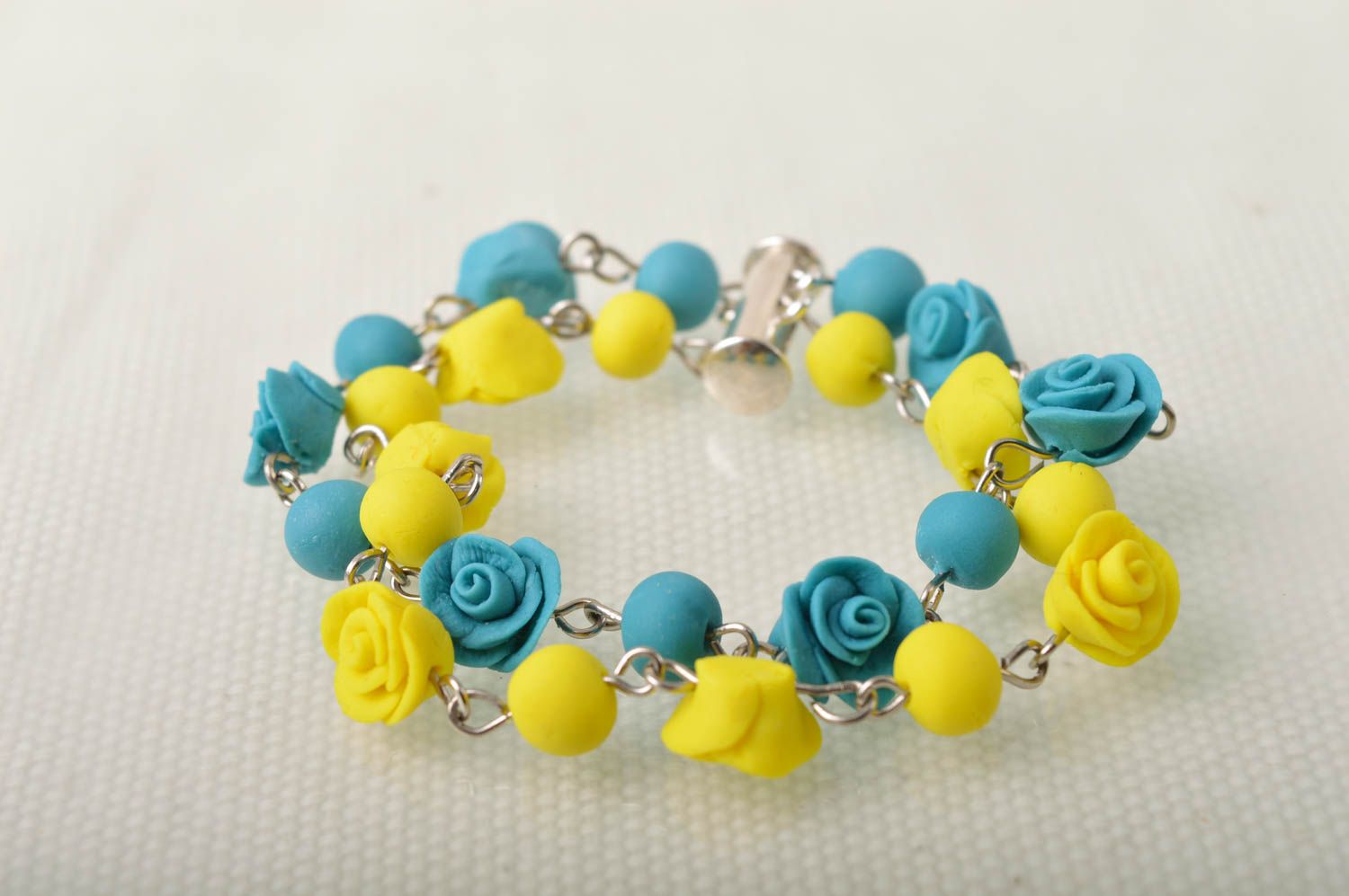 Handmade bright wrist bracelet with blue and yellow cold porcelain rose flowers photo 1