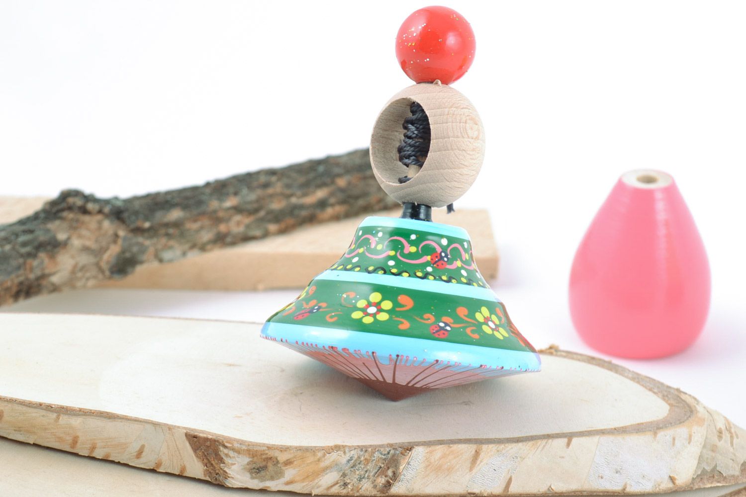 Bright handmade painted wooden toy spinning top with ring for children's fine motor skills photo 1