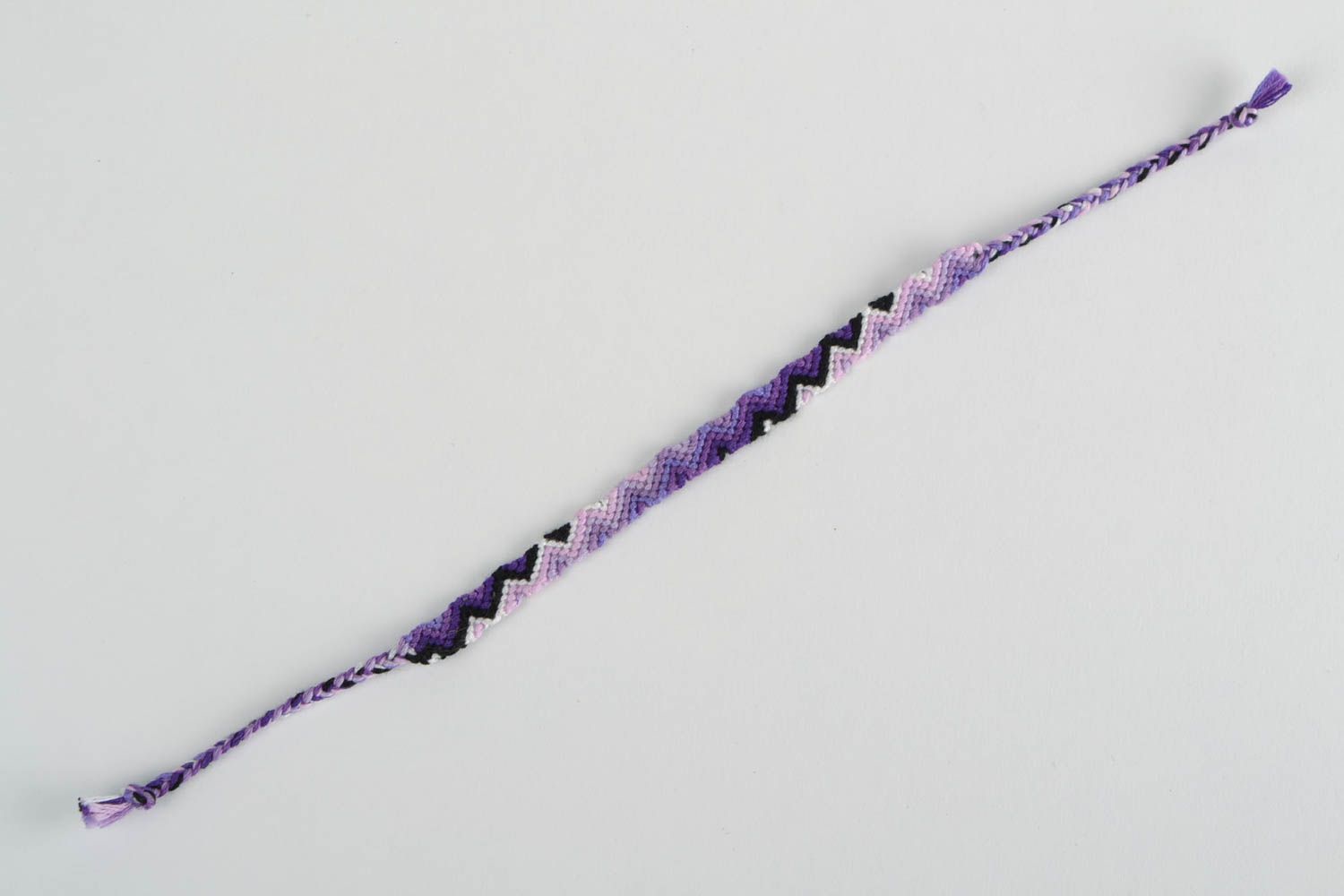 Handmade thin friendship wrist bracelet woven of threads in violet color shades photo 5