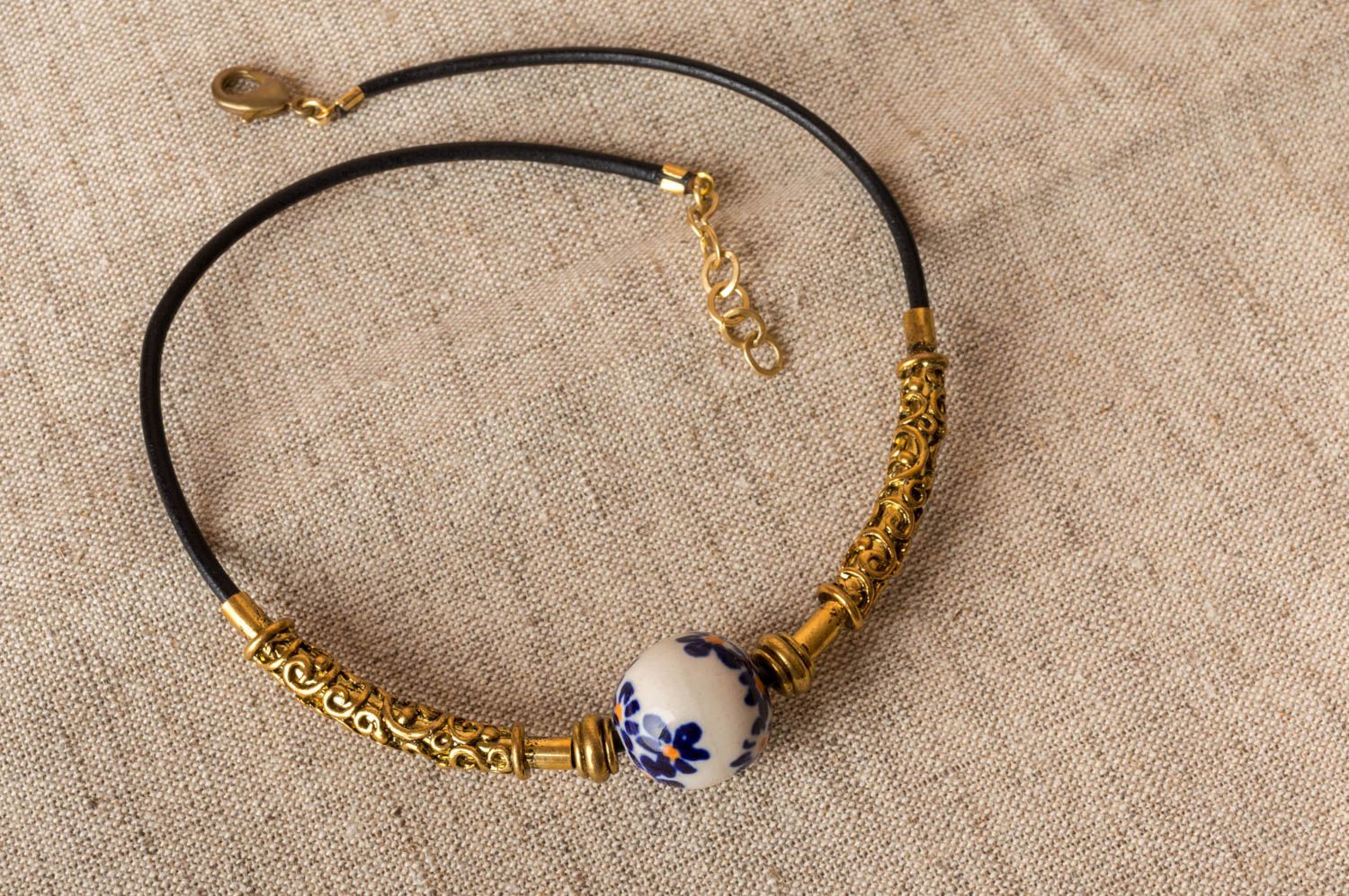 Handmade necklace choker made of brass with porcelain bead on leather lace photo 1