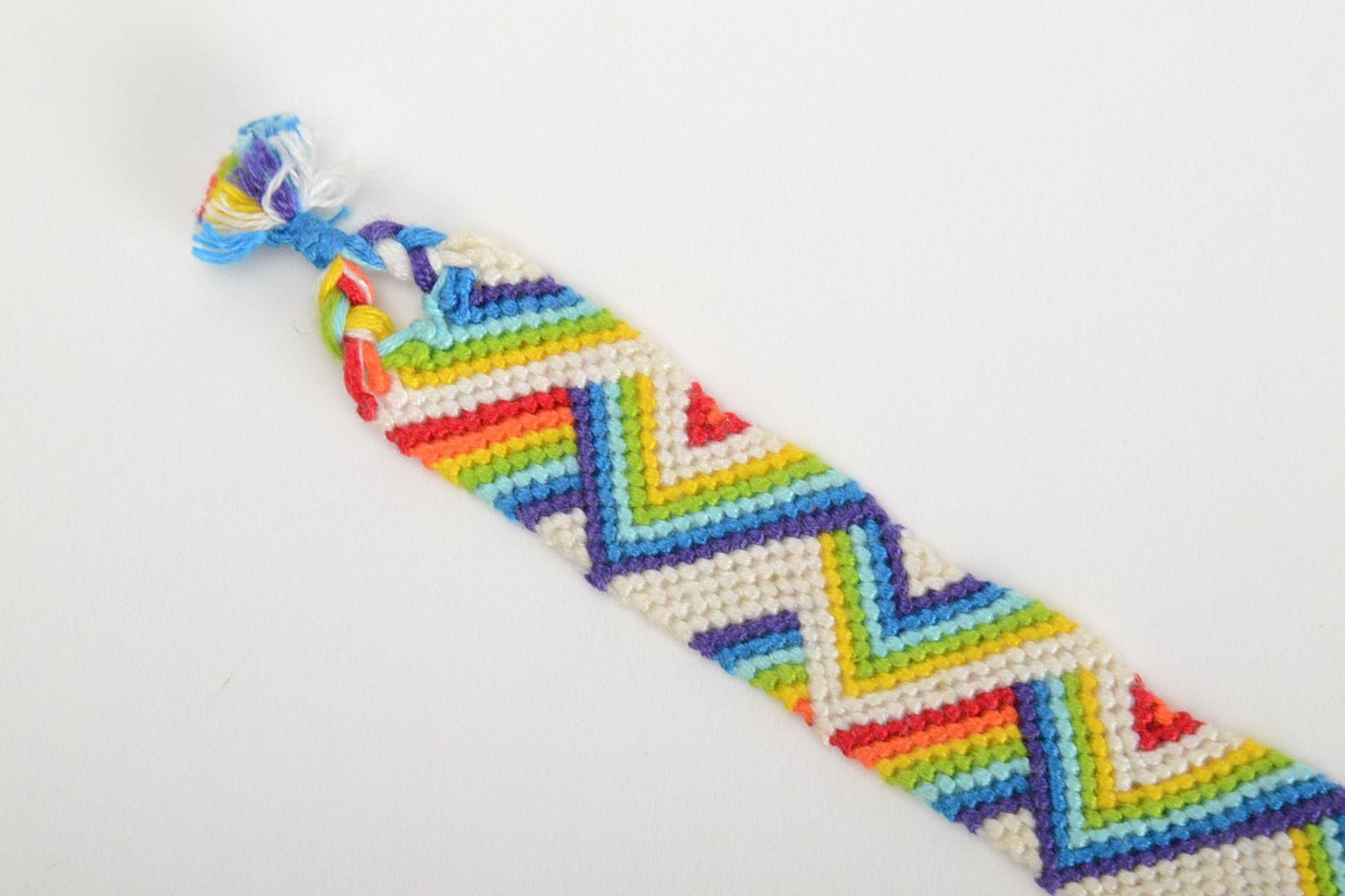 Handmade friendship bracelet woven of threads with rainbow colored ornament photo 4