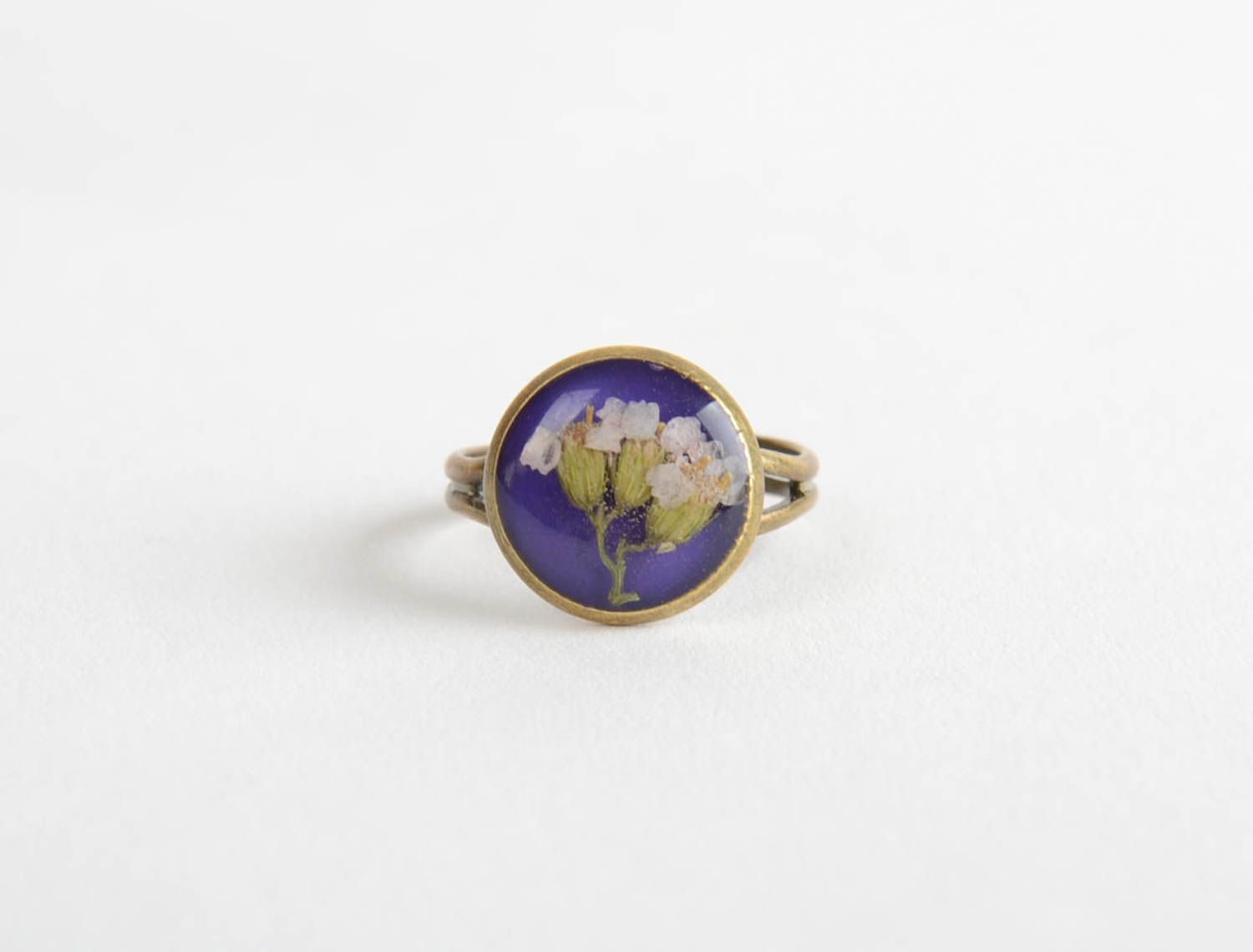 Small round handmade ring with dried flowers in epoxy resin on metal basis photo 3