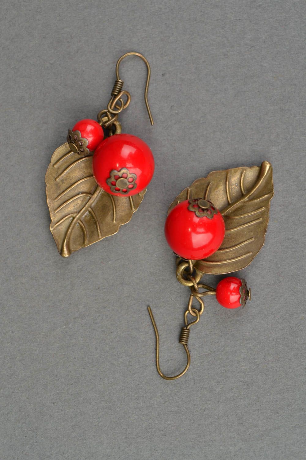 Metal leaf-earrings with ceramic beads of coral color photo 3