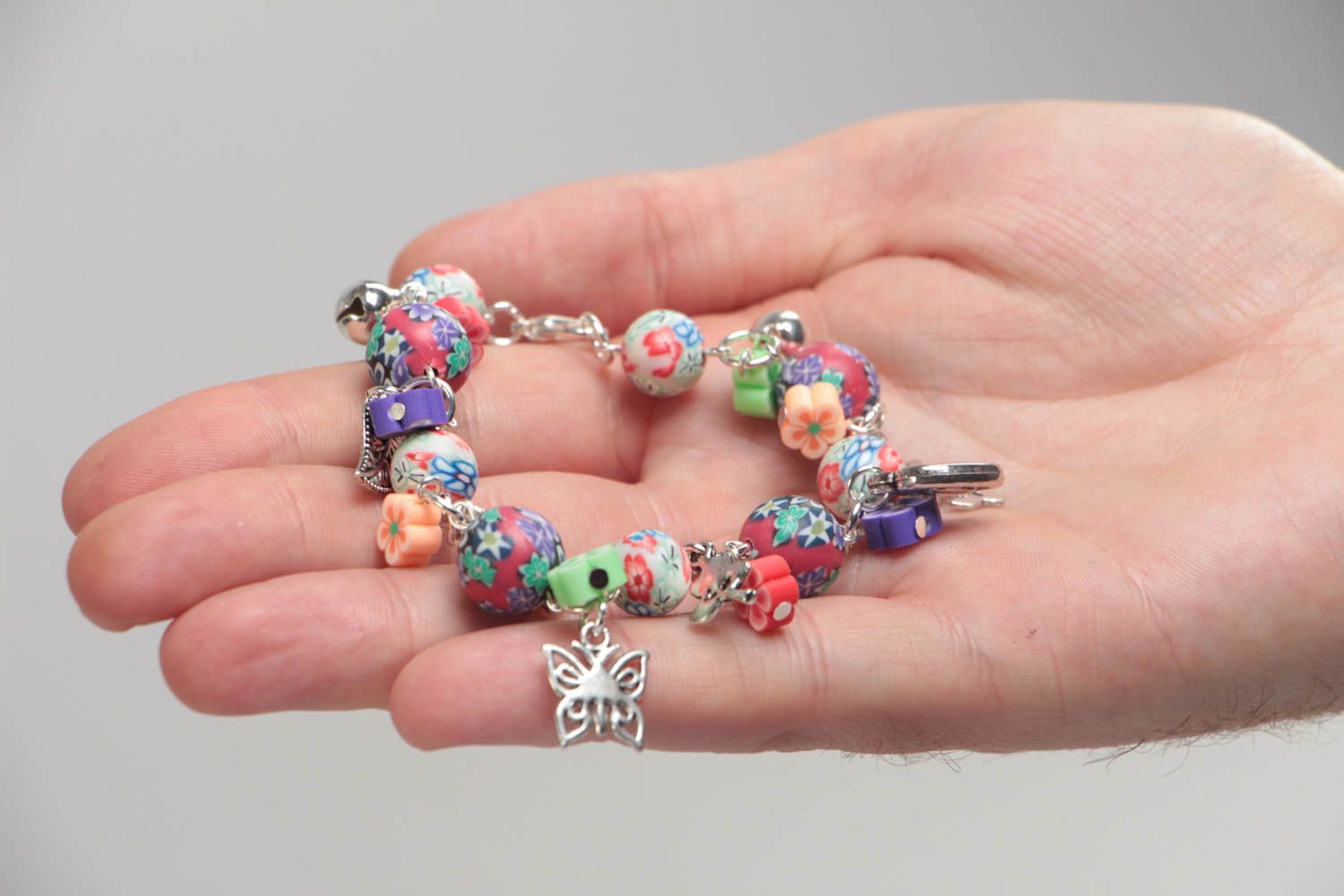 Unusual beautiful handmade children's plastic wrist bracelet with charms photo 5