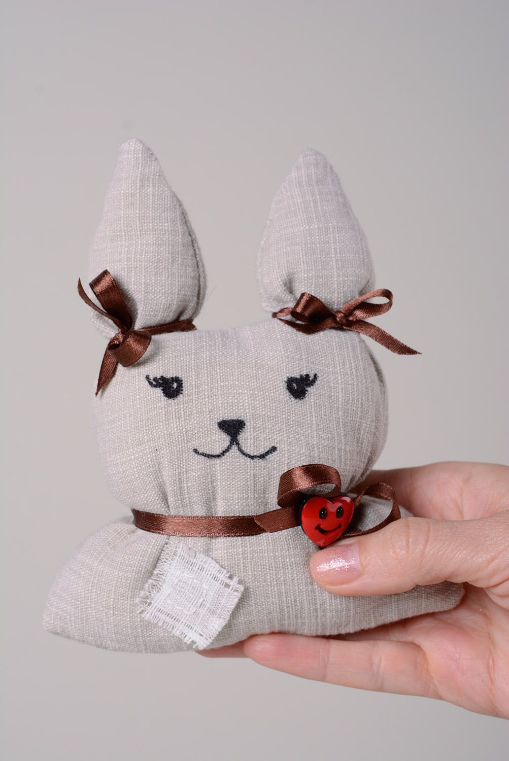 Handmade soft toy sewn of fabric and cotton wool with ribbons Hare photo 3