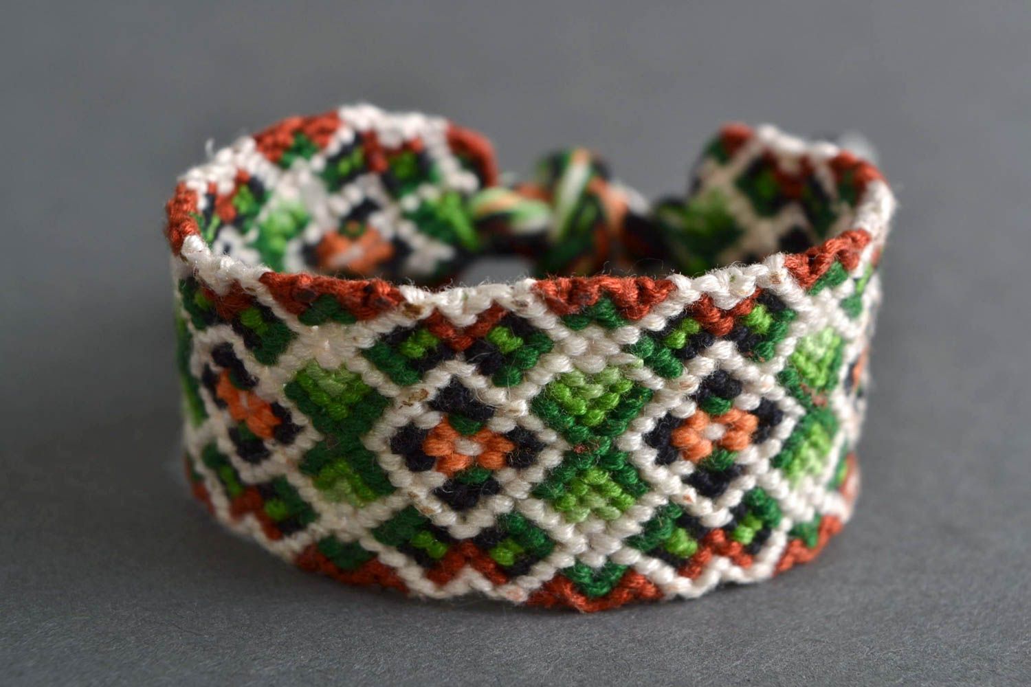 Handmade designer friendship bracelet with green and white geometric ornament  photo 1