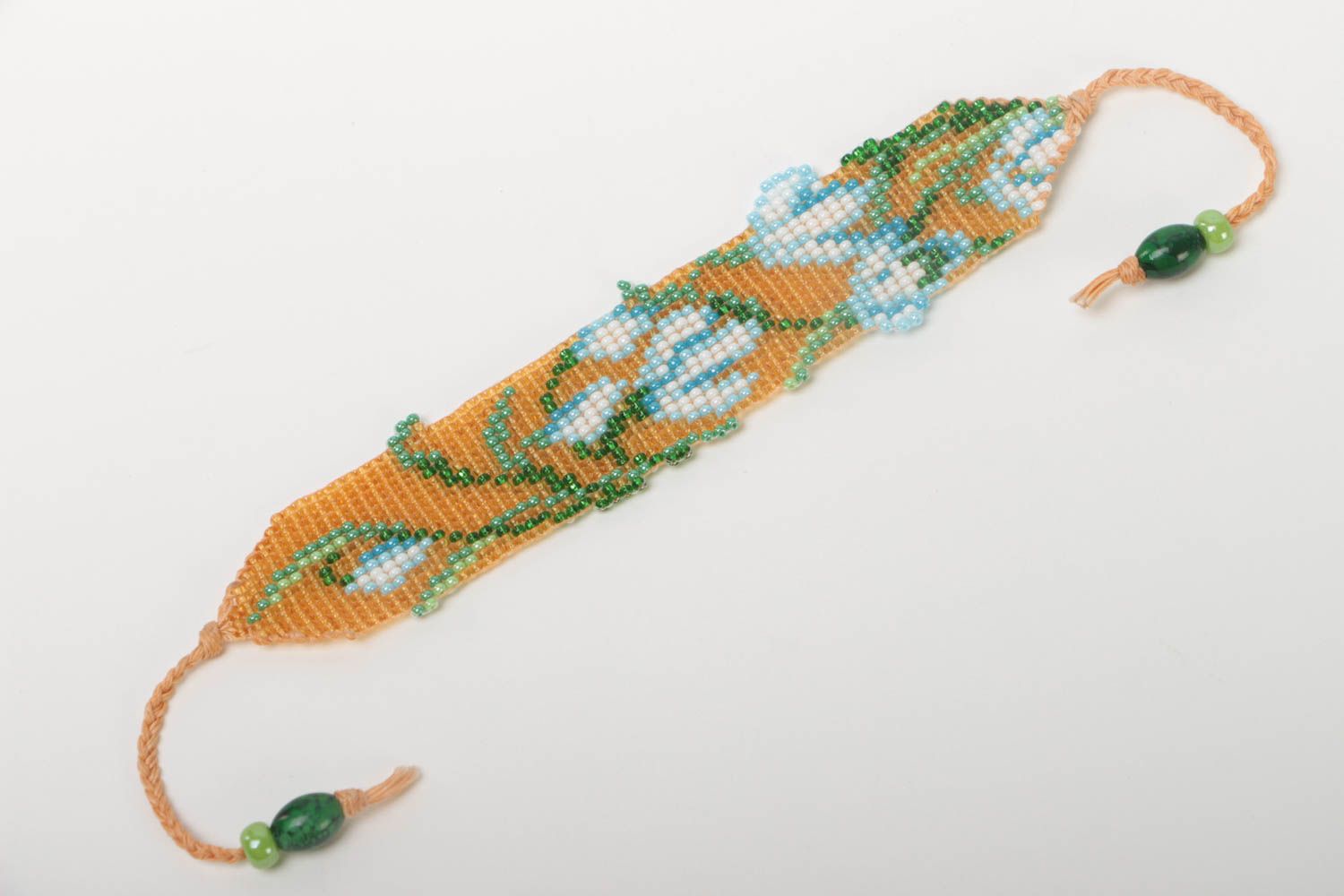 Floral ornament strand bracelet in pale orange, blue, green color for young girls photo 2
