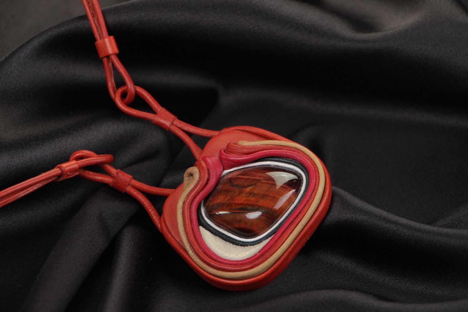 Handmade stylish designer pendant made of genuine leather with red stone  photo 1
