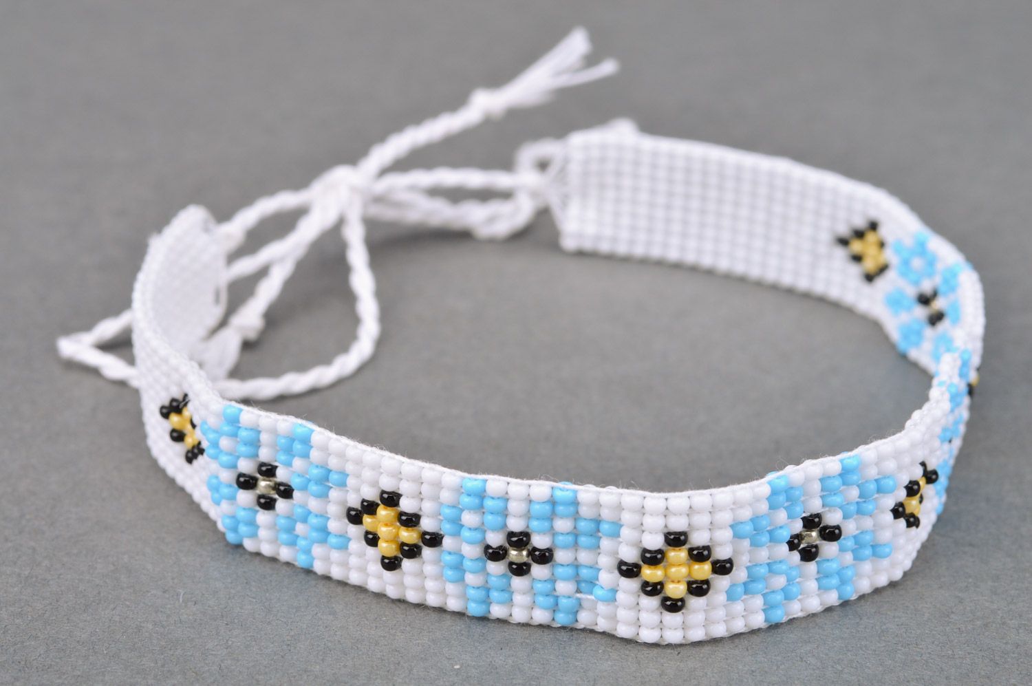 Beautiful women's handmade woven Czech bead necklace of white color with blue flowers photo 2