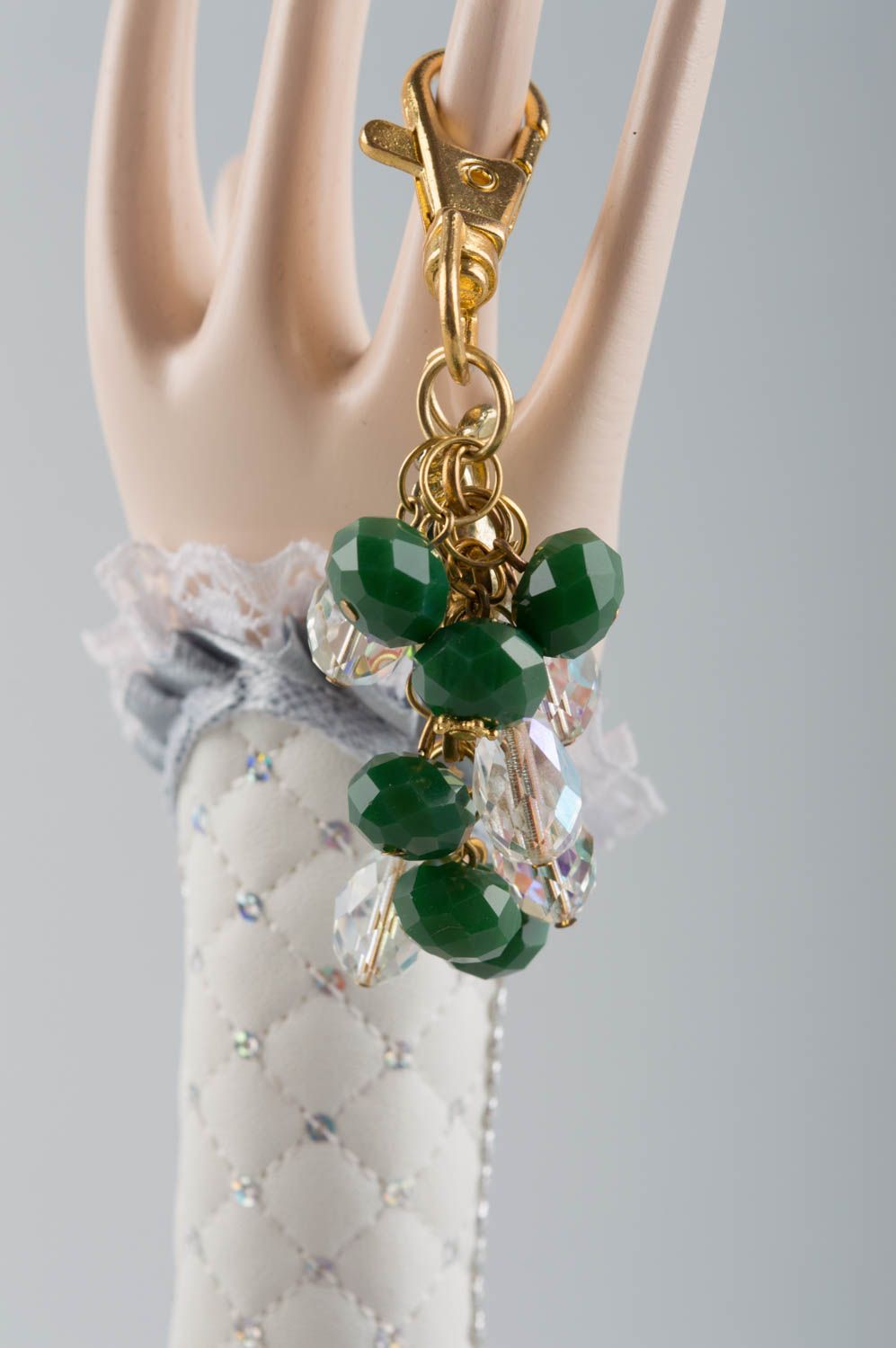 Handmade fashionable keychain with latten basis and green glass beads photo 1