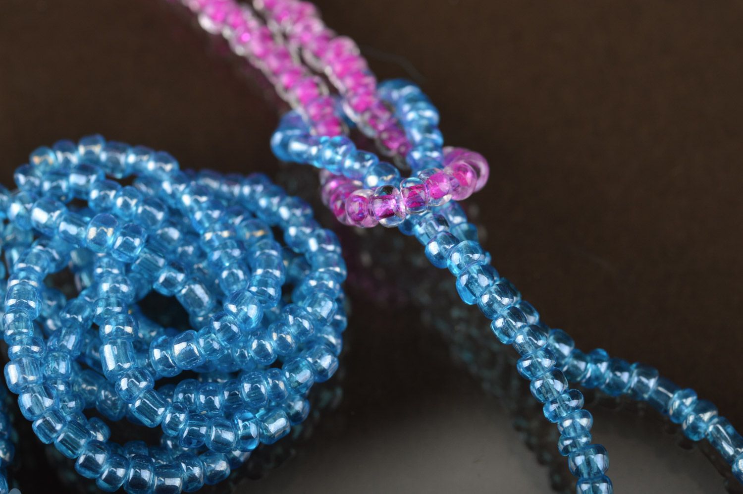 Set of handmade beaded jewelry long earrings and wrist bracelet on blue color photo 4