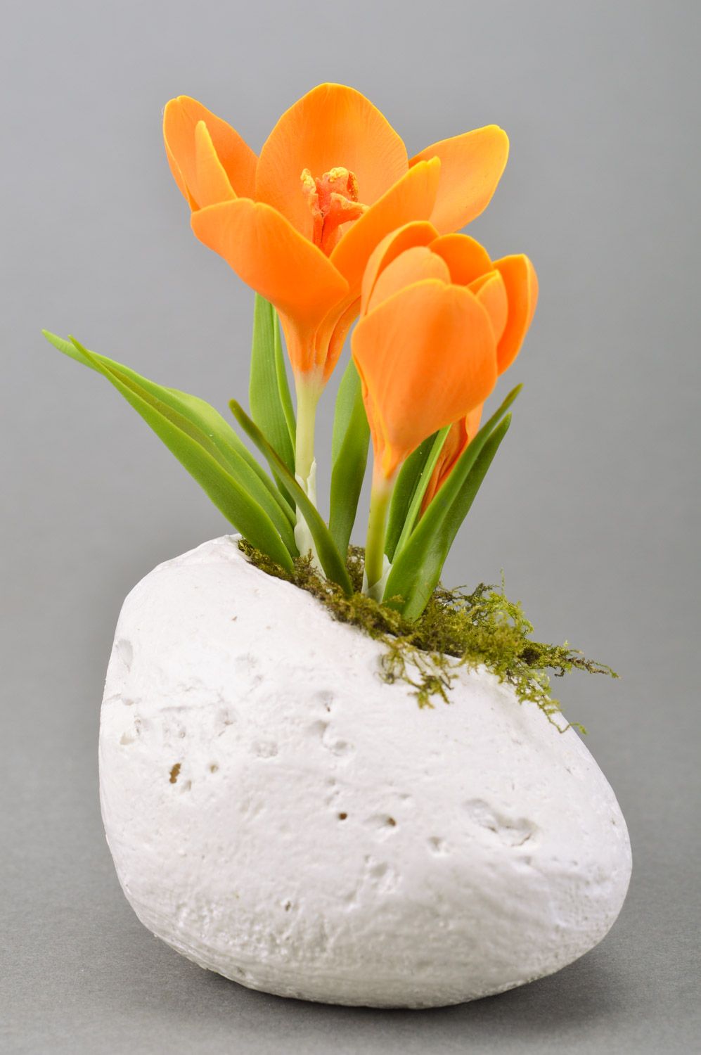 Handmade decorative crocus flower of orange color molded of polymer clay on stone photo 3