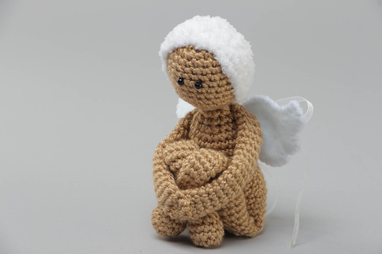 Small handmade knitted angel toy made of acrylic yarn using knitting needle photo 2