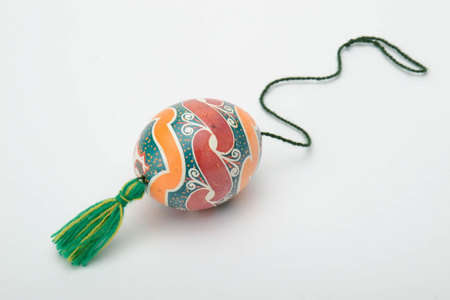 Handmade decorative colorful painted Easter egg pysanka with green tassel photo 4