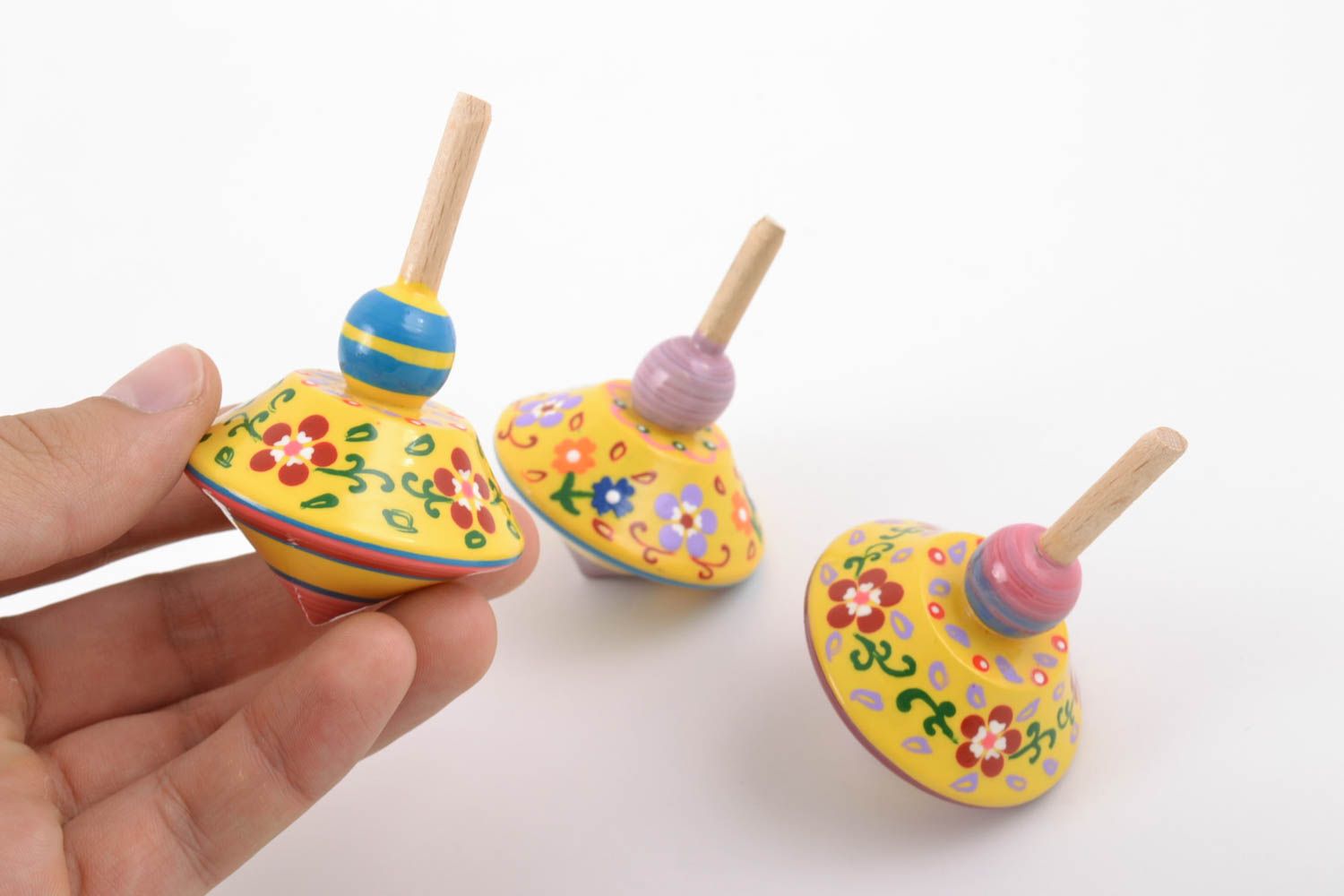 Set of handmade yellow painted wooden toys eco spinning tops 3 pieces photo 2