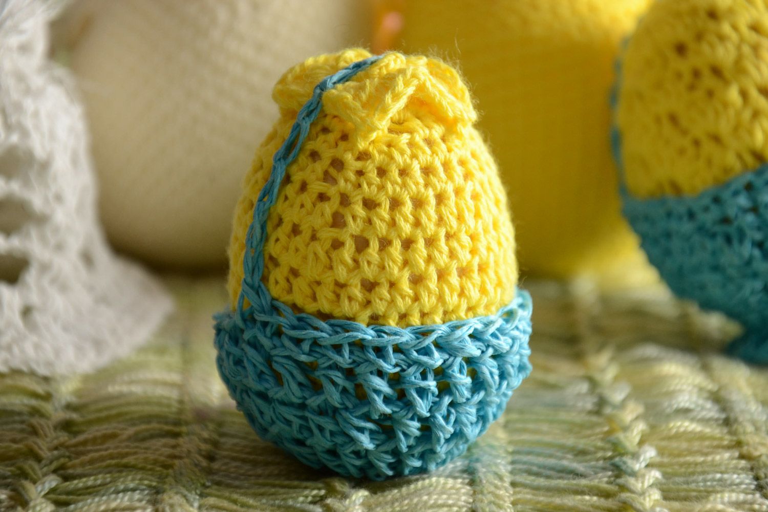 Handmade wooden egg crocheted over with yellow and blue threads Easter decoration photo 1