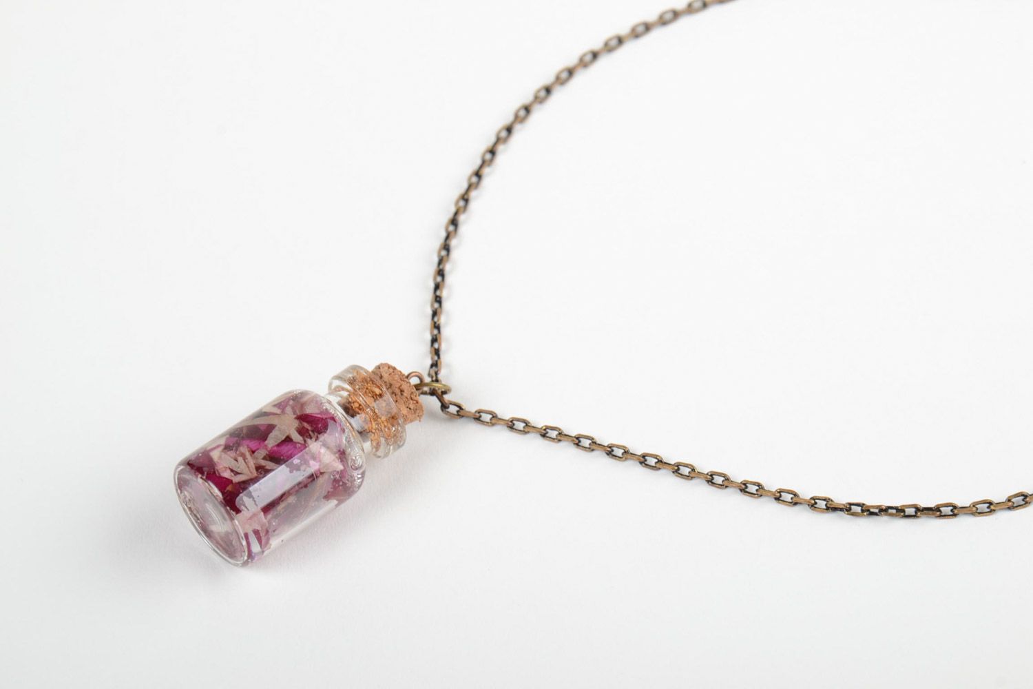 Handmade epoxy resin neck pendant with real flowers inside in the shape of transparent vial photo 3