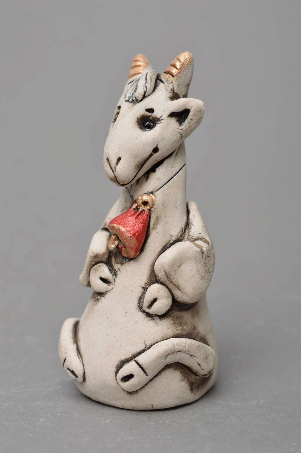 Handmade designer small white glazed porcelain figurine of goat with red bell photo 3