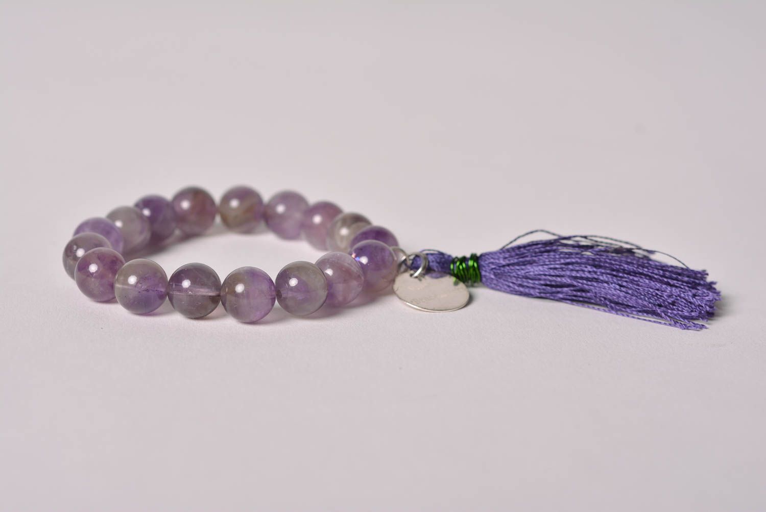 Handmade tender wrist bracelet with amethyst beads and thread tassel for women photo 4