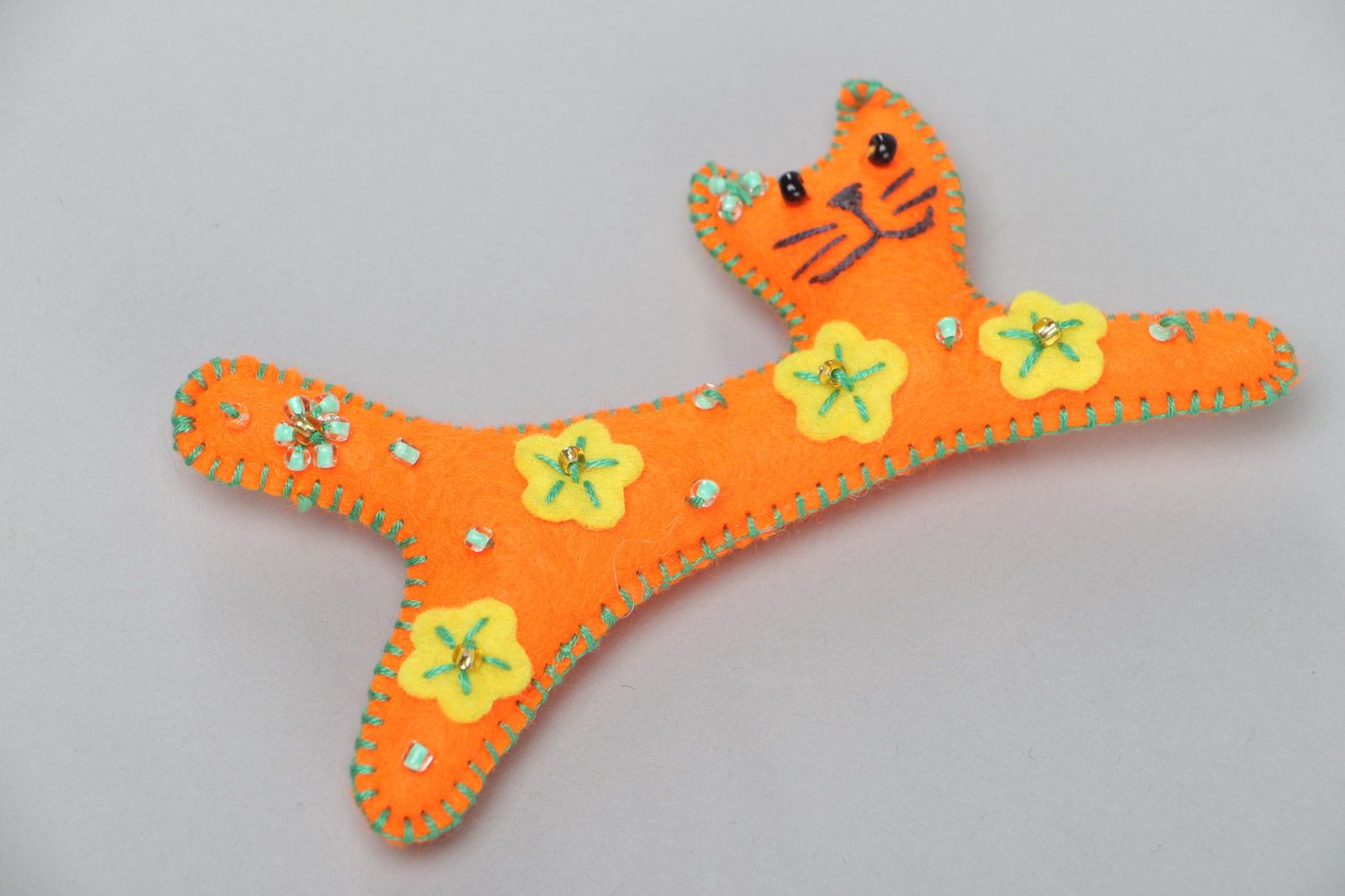 Handmade small soft toy sewn of felt in the shape of long orange kitten  photo 2