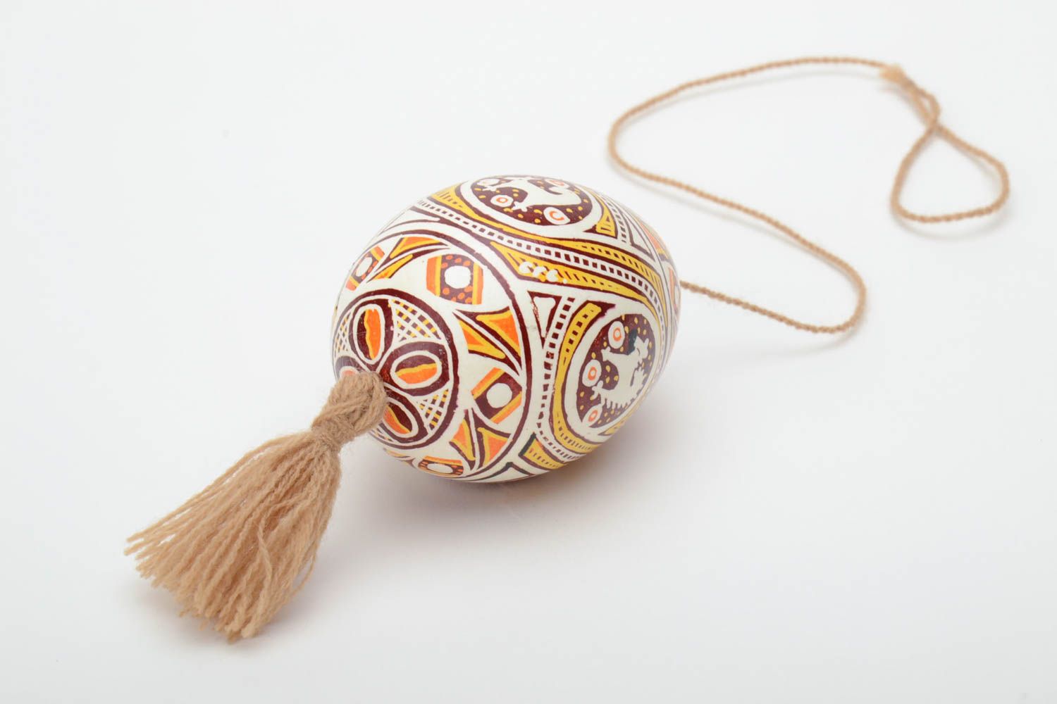 Homemade painted Easter egg with tassel and patterns created using waxing technique photo 4