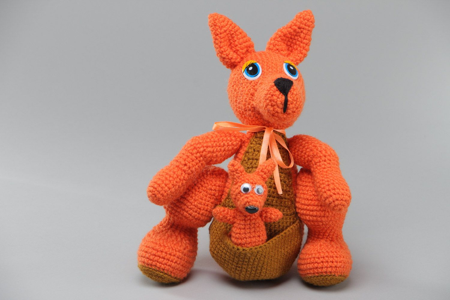 Small orange handmade crochet soft toy in the shape of kangaroo with baby photo 2