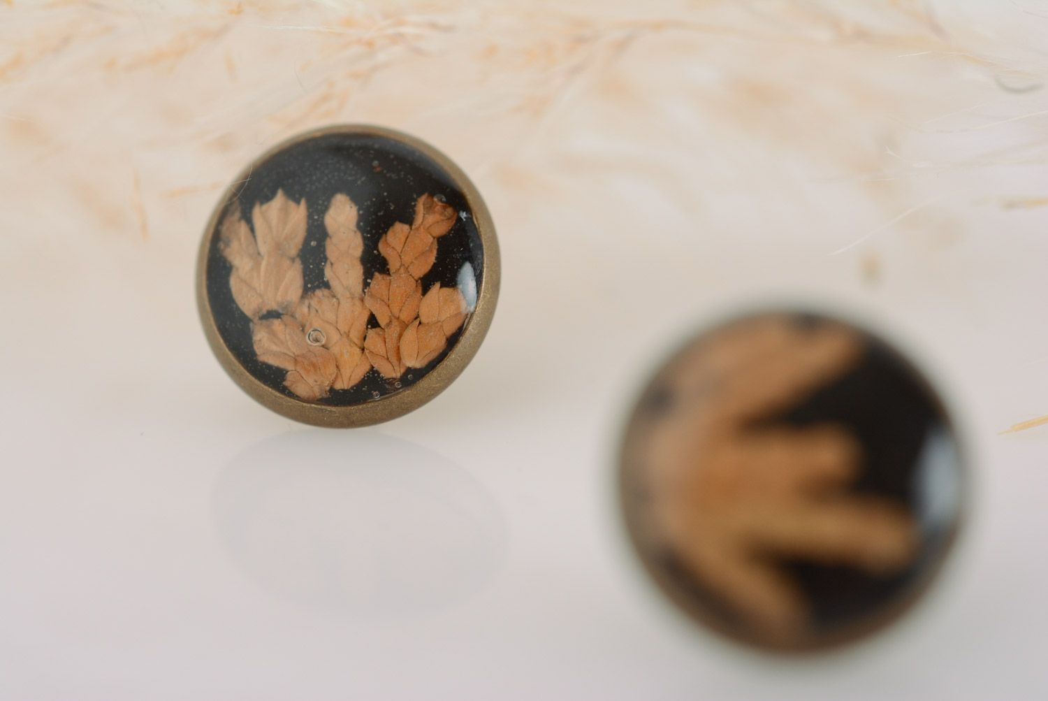 Small round homemade black stud earrings with dried flower in epoxy resin photo 3