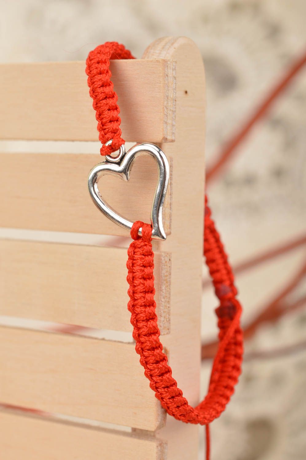 Handmade red bracelet made of silk threads with insert in shape of heart photo 1