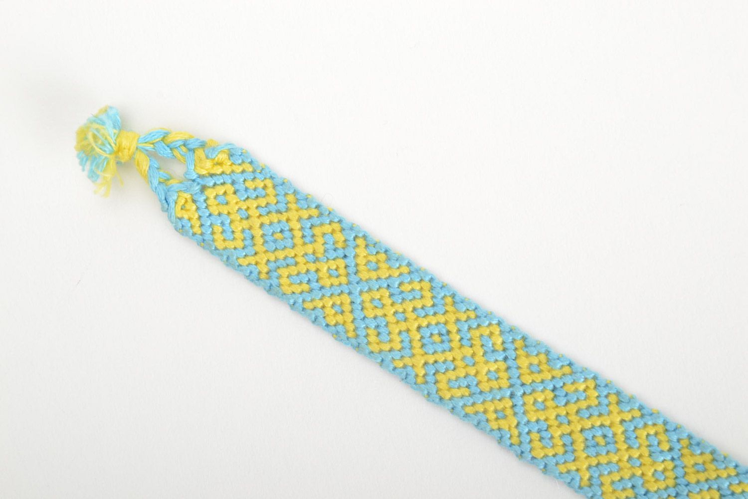 Handmade friendship wrist bracelet woven of blue and yellow threads with ties photo 4