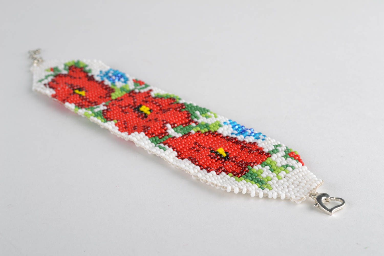 Wide beaded bracelet with flower ornament photo 1
