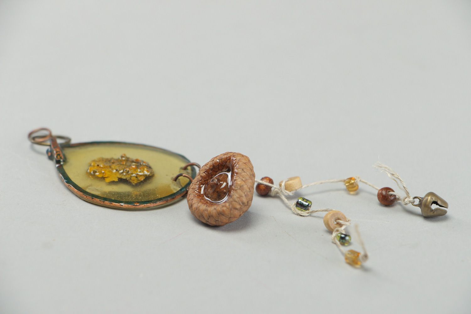 Handmade neck pendant with bark and acorn hat embedded in epoxy resin  photo 2
