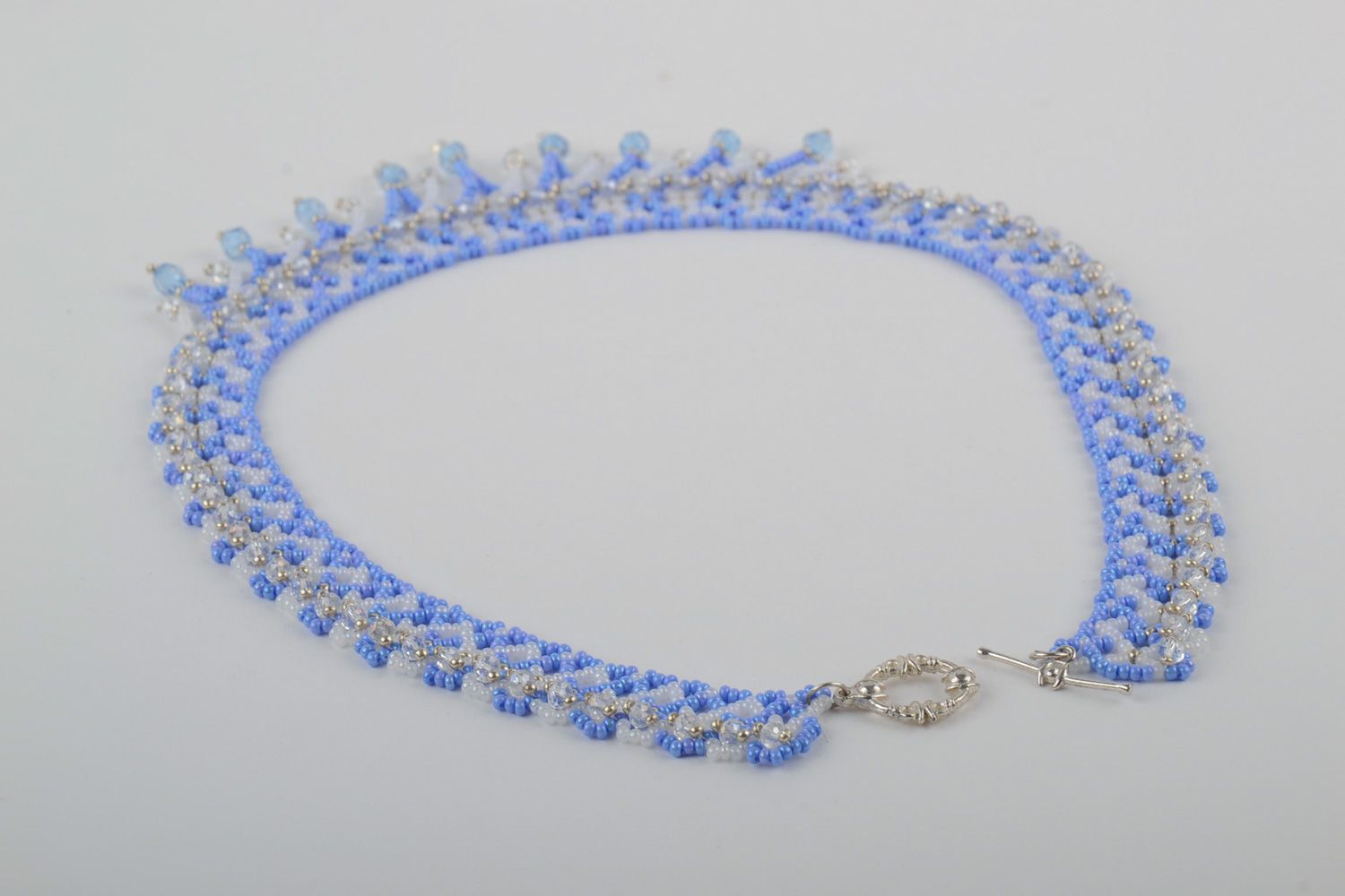 Handmade women's beaded necklace with charms of blue color photo 3