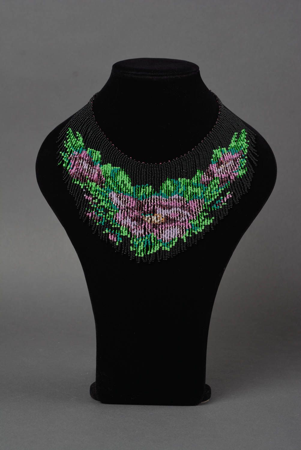 Beaded handmade necklace with lilac flowers on black background stylish jewelry photo 2
