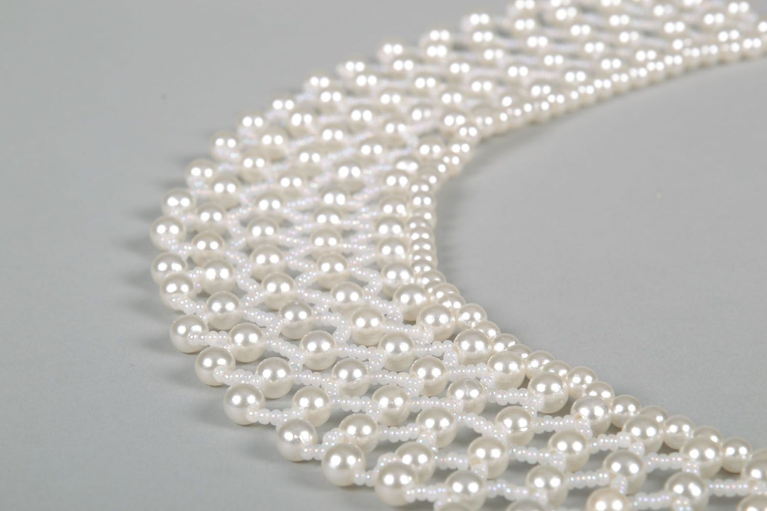 Lacy necklace made of white beads photo 4
