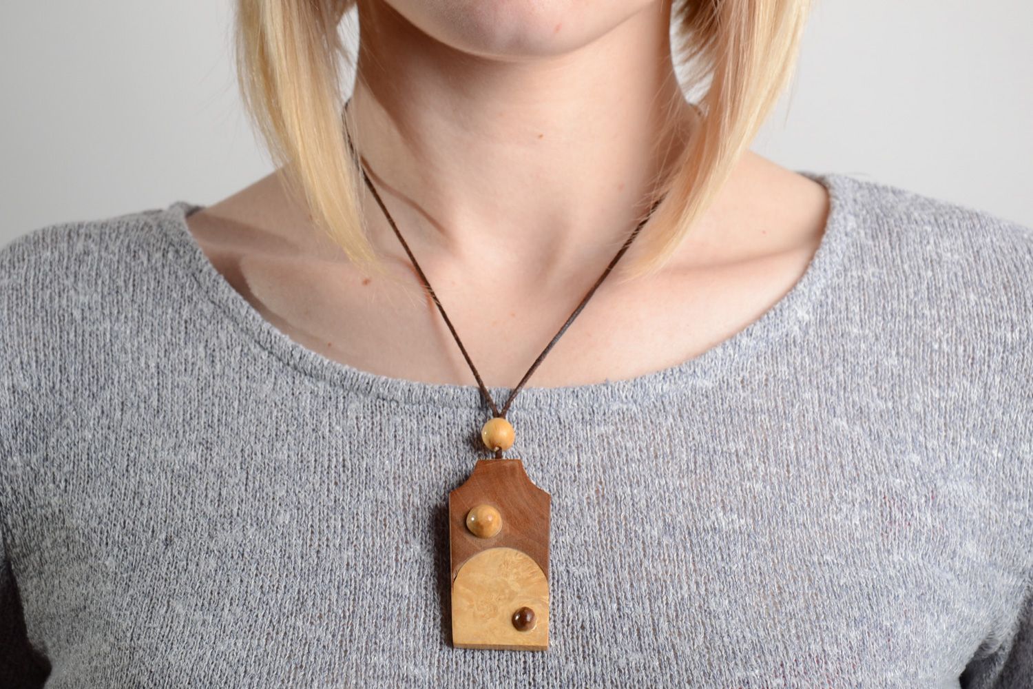 Laconic handmade two colored carved wooden neck pendant on cord for women photo 2