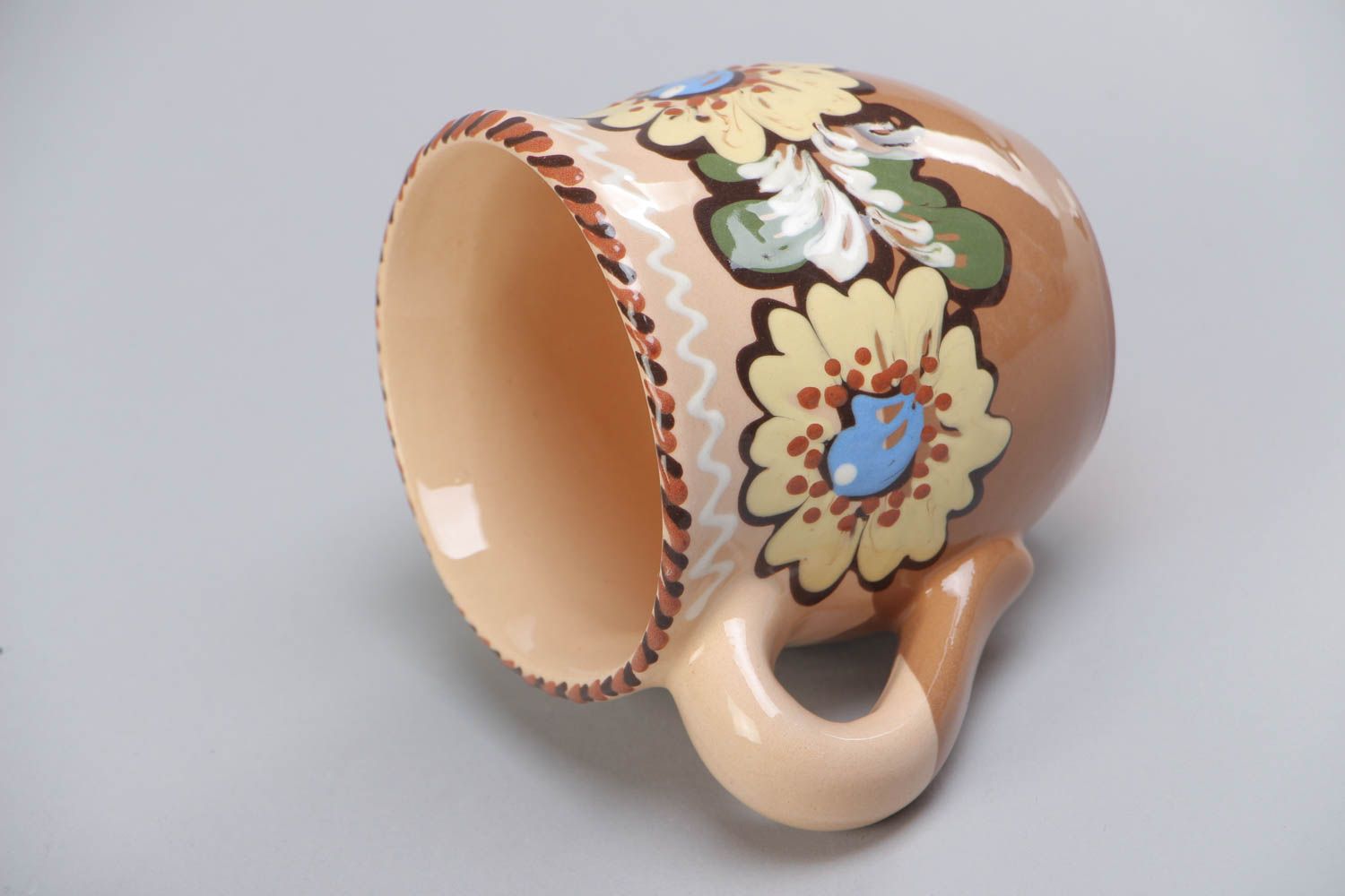 10 oz clay glazed cup with handle and floral design in brown, beige, and blue color photo 4