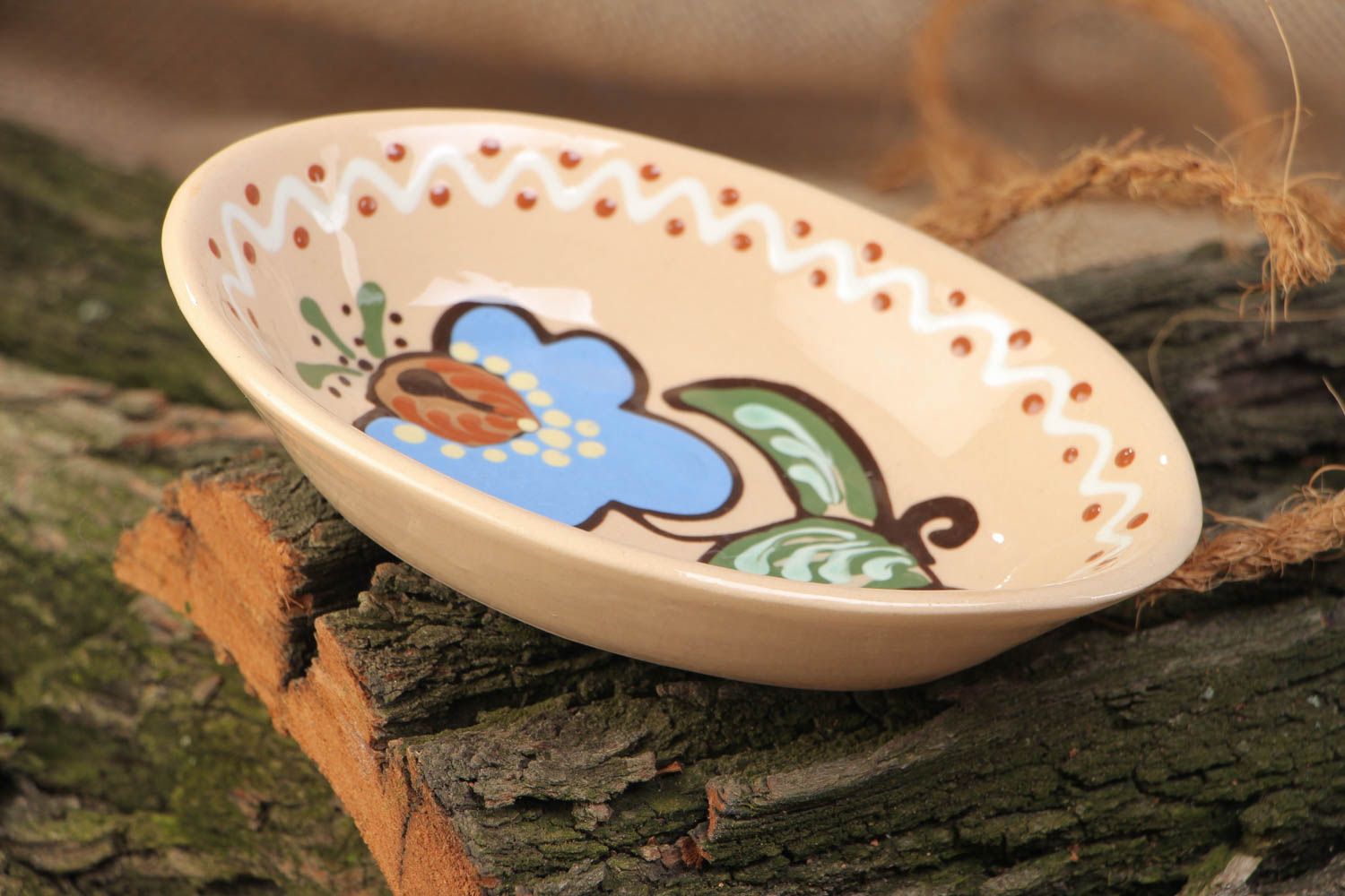 Light ceramic bowl with handmade floral painting with glaze in ethnic style  photo 1