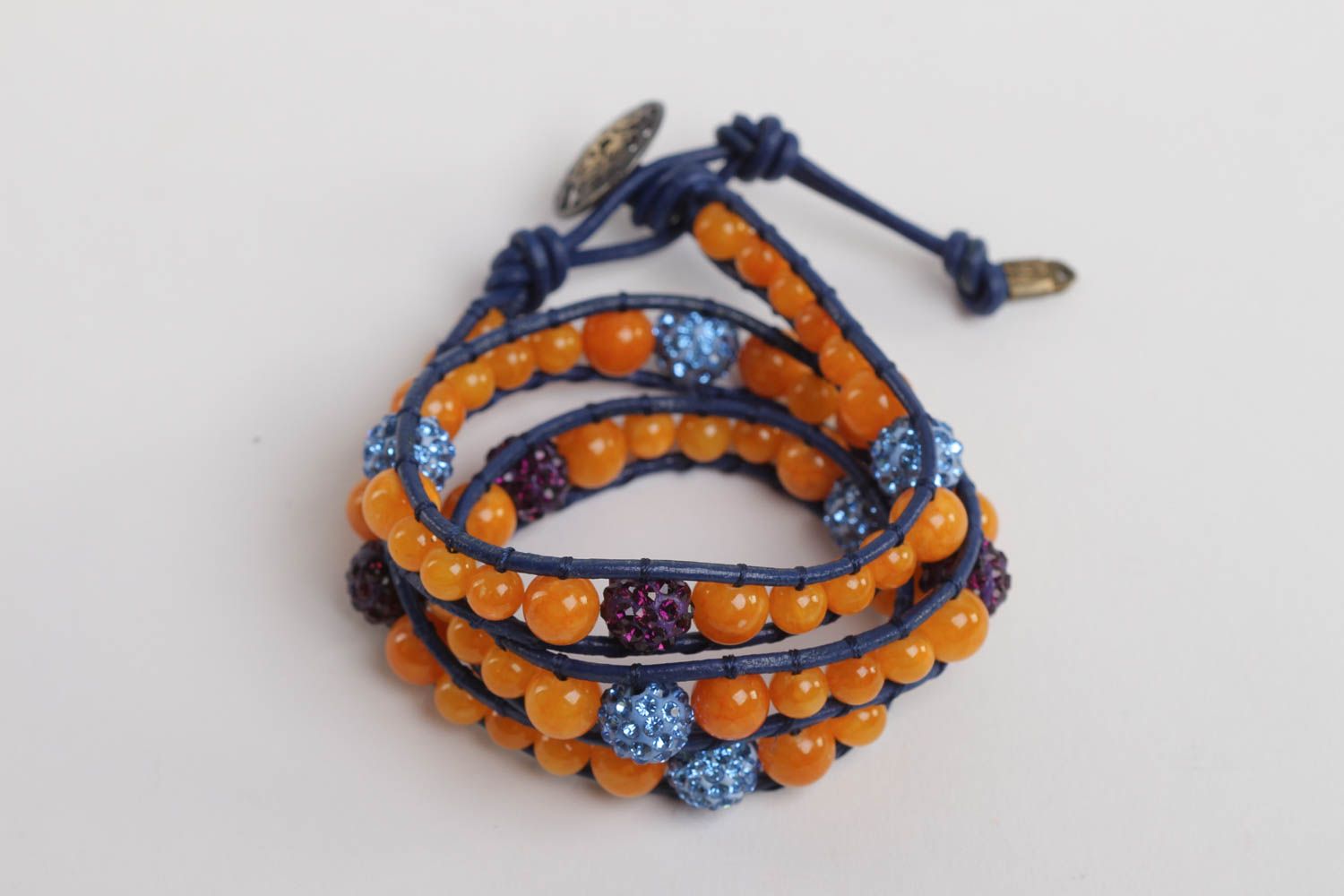 Three-layer orange beads strand bracelet on dark blue cord photo 2