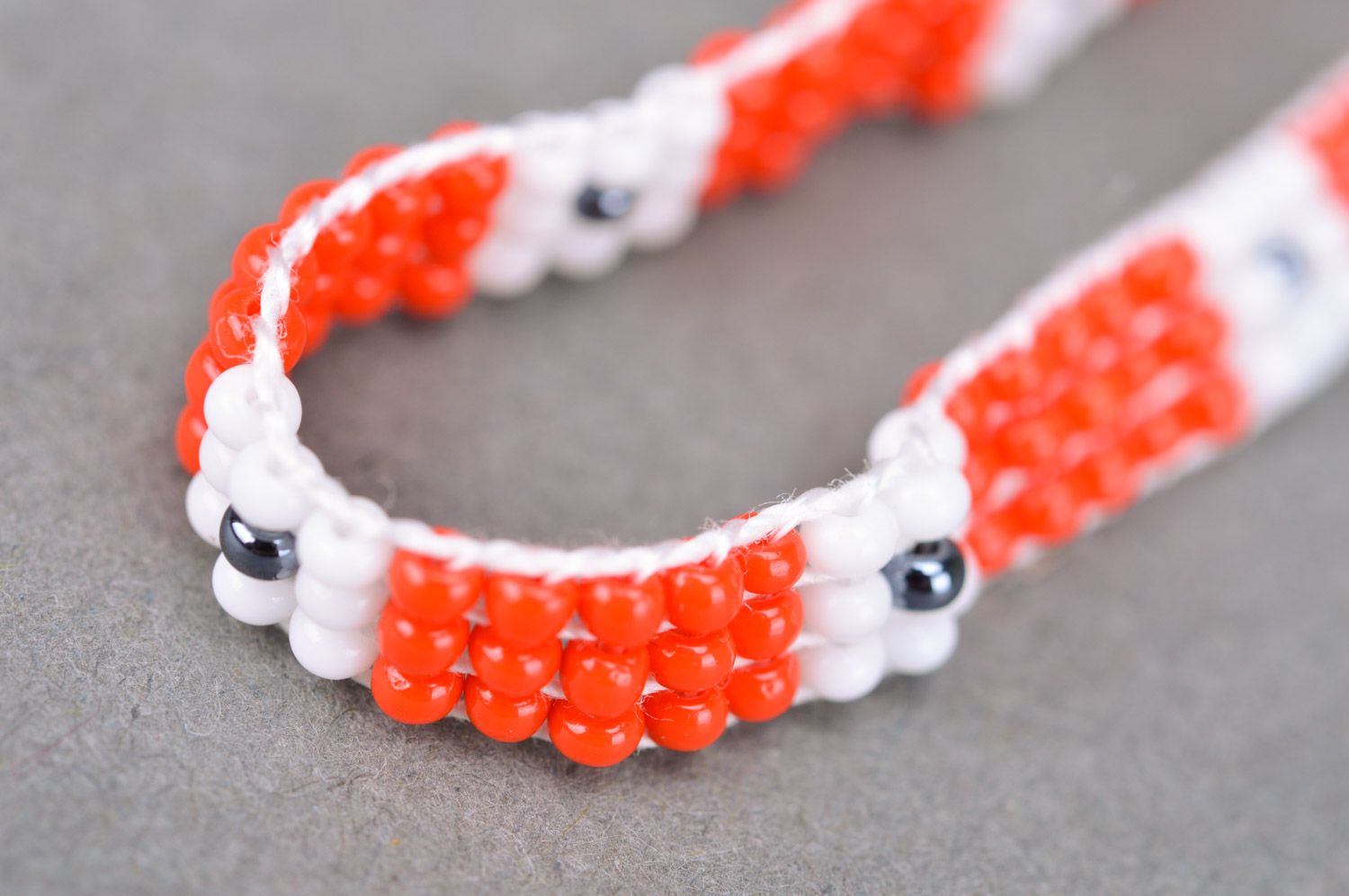 Handmade woven women's thin beaded wrist bracelet of red and white colors photo 4